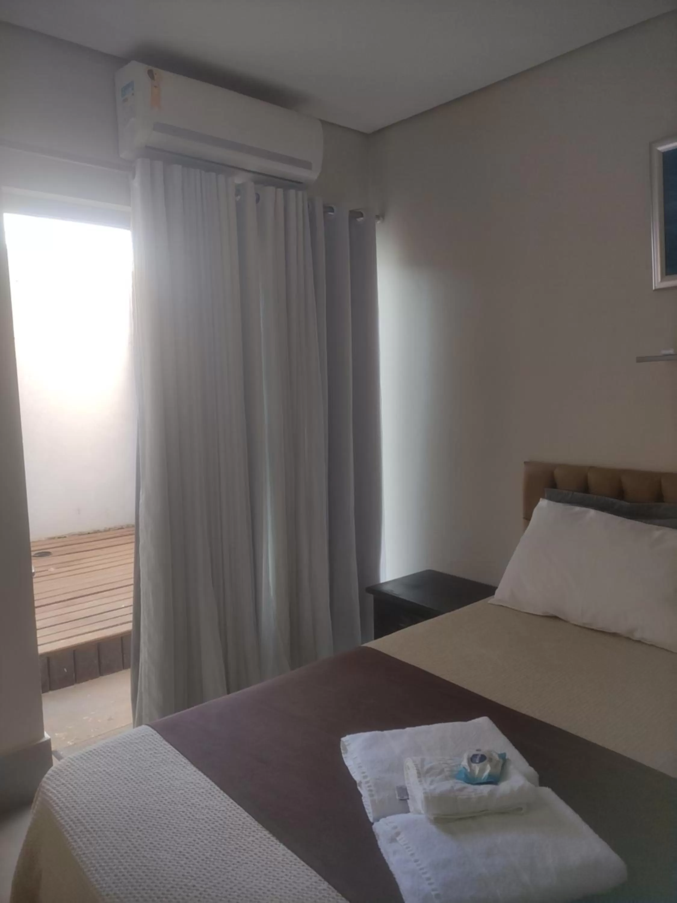 Bed in Pousada da Gi Suítes e Turismo