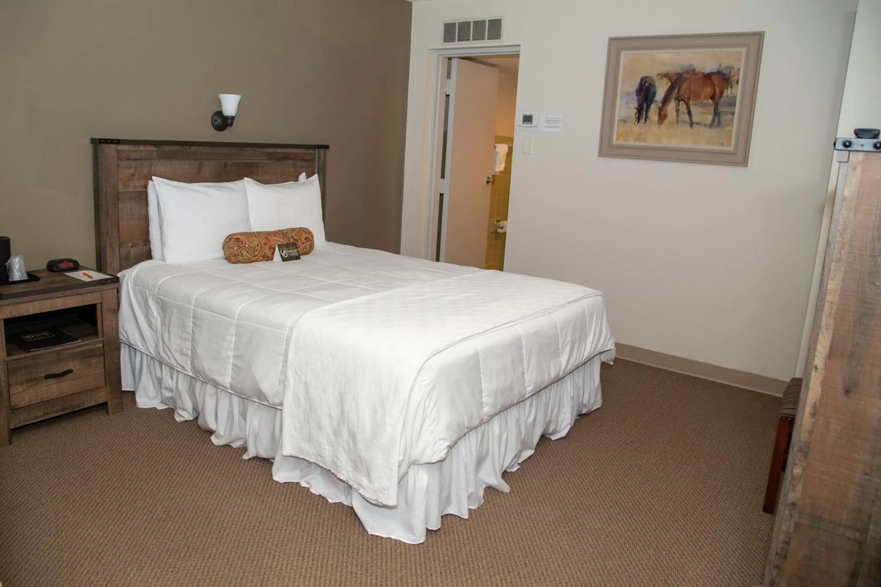 Bed in The Stables Inn & Suites