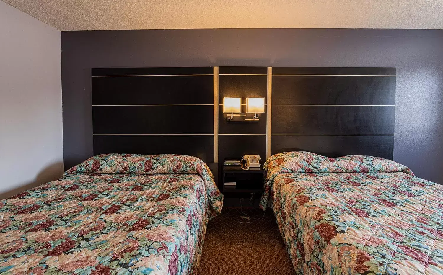 Bed in Coratel Inn & Suites by Jasper Hastings