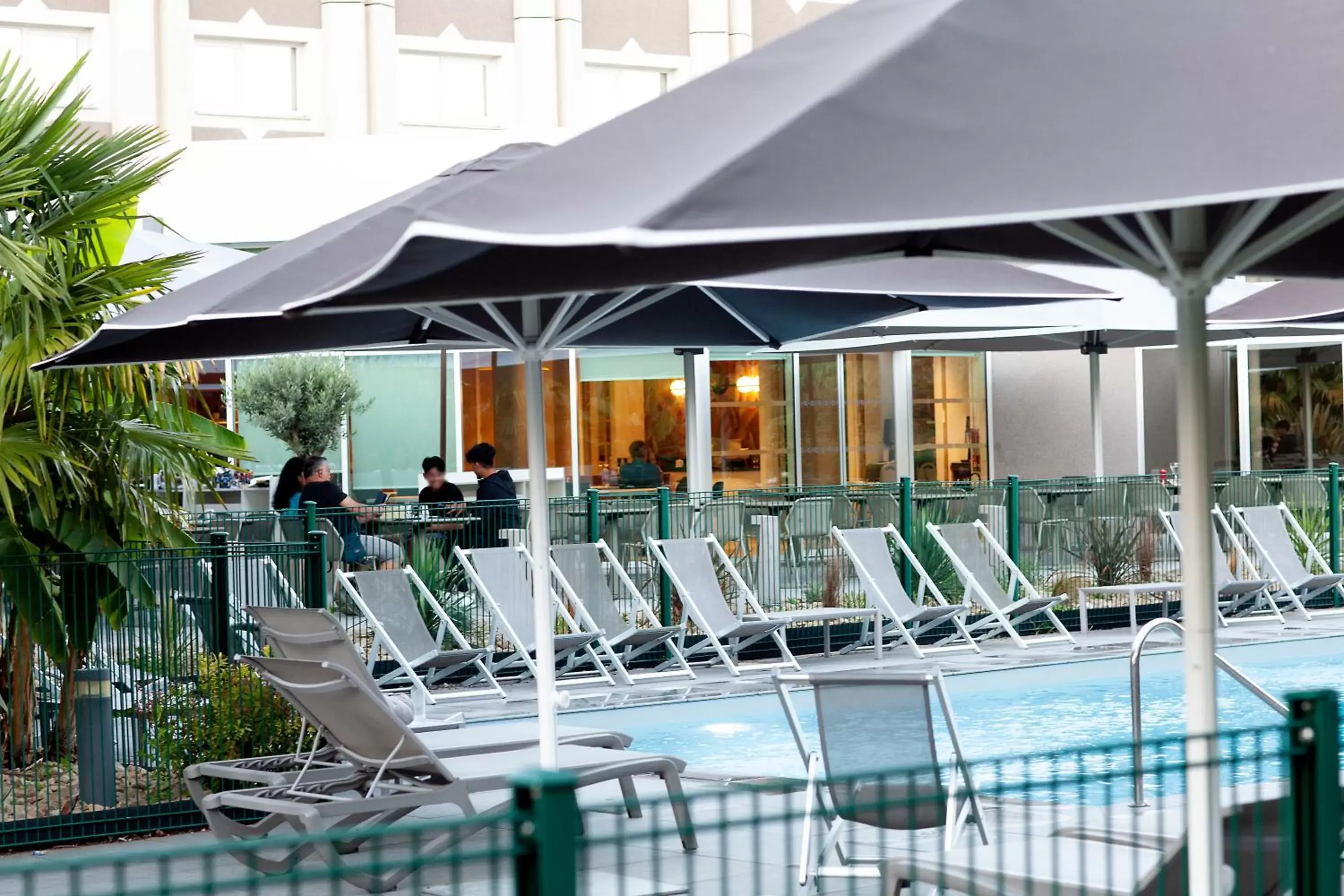 Patio, Swimming Pool in Novotel Clermont-Ferrand