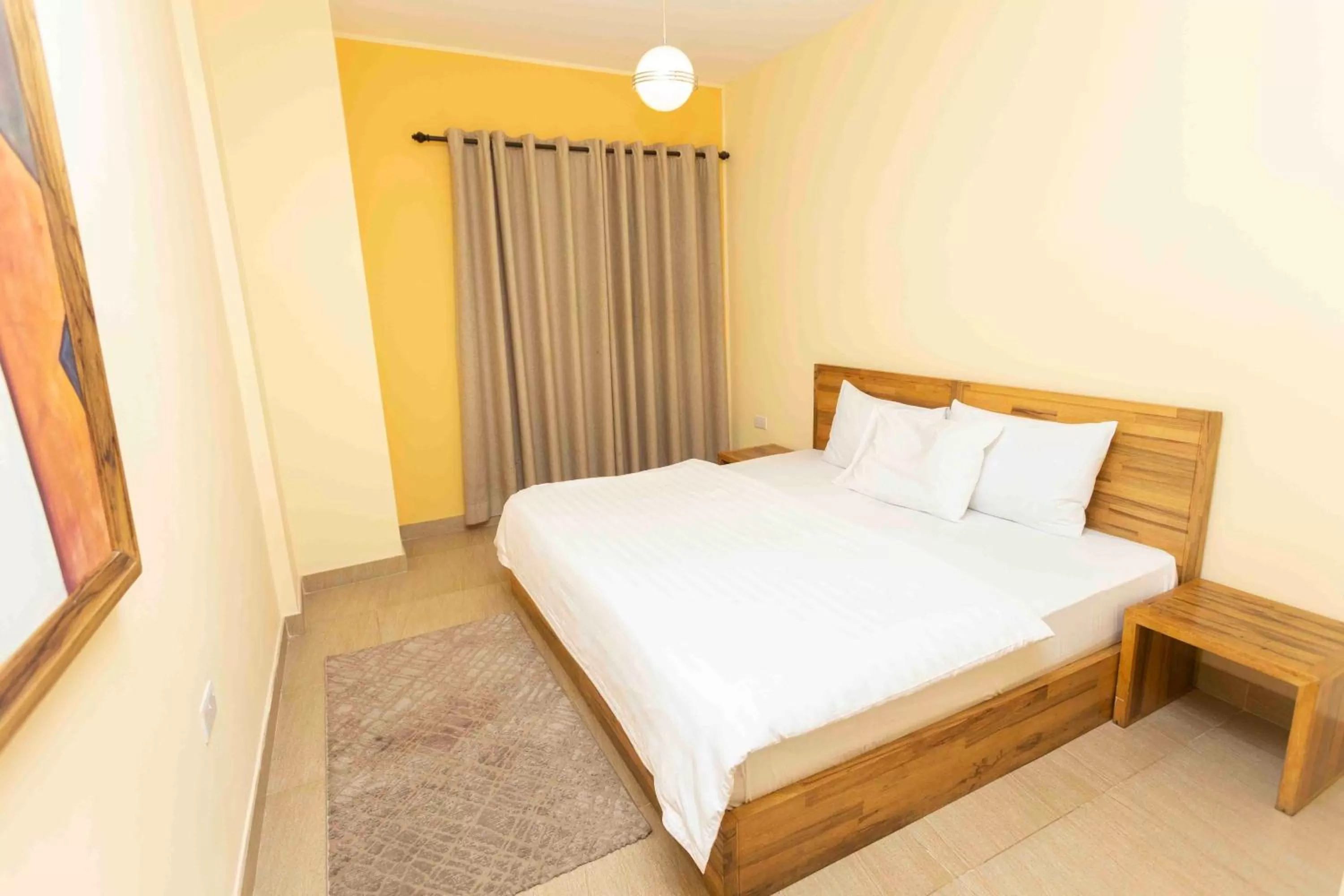 Bed in Roots Hotel Apartment