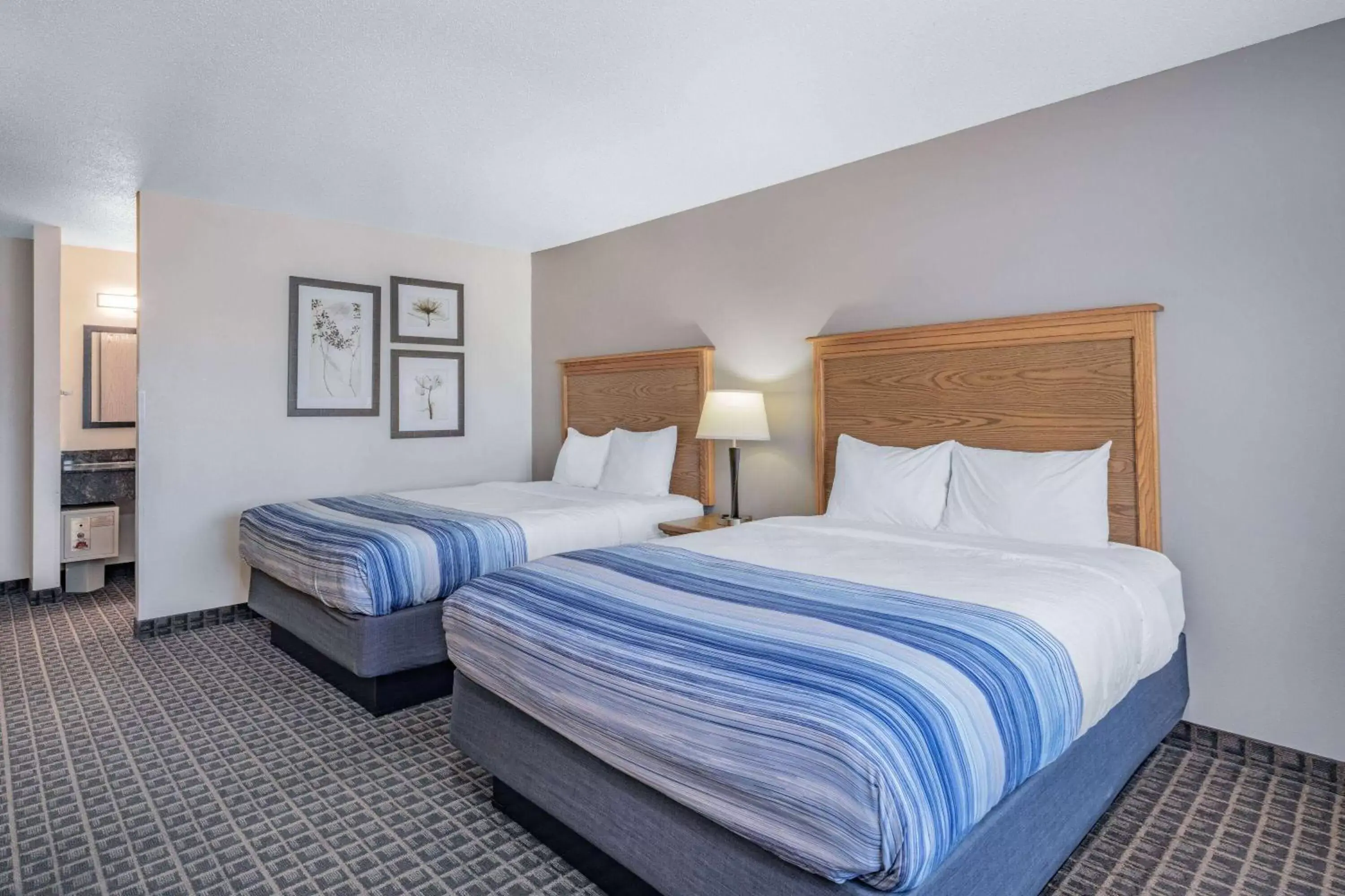 Queen Room with Two Queen Beds - Non-Smoking in AmericInn by Wyndham Aberdeen Event Center