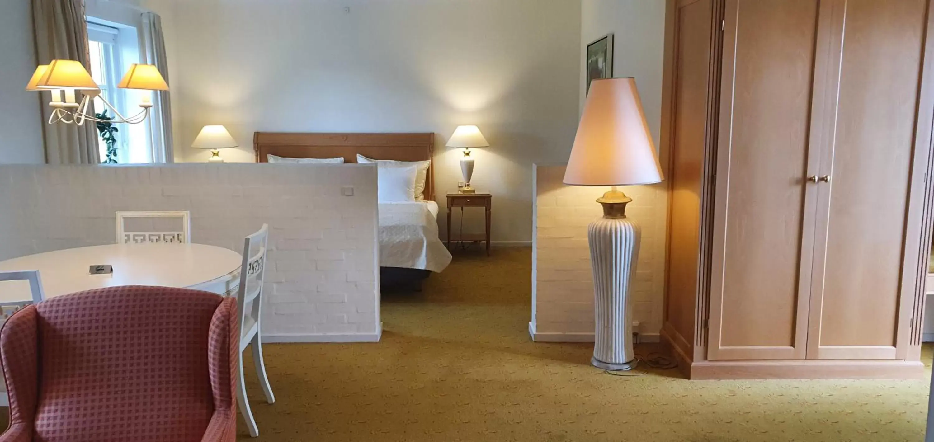 Seating area, Bed in Hotel Knudsens Gaard