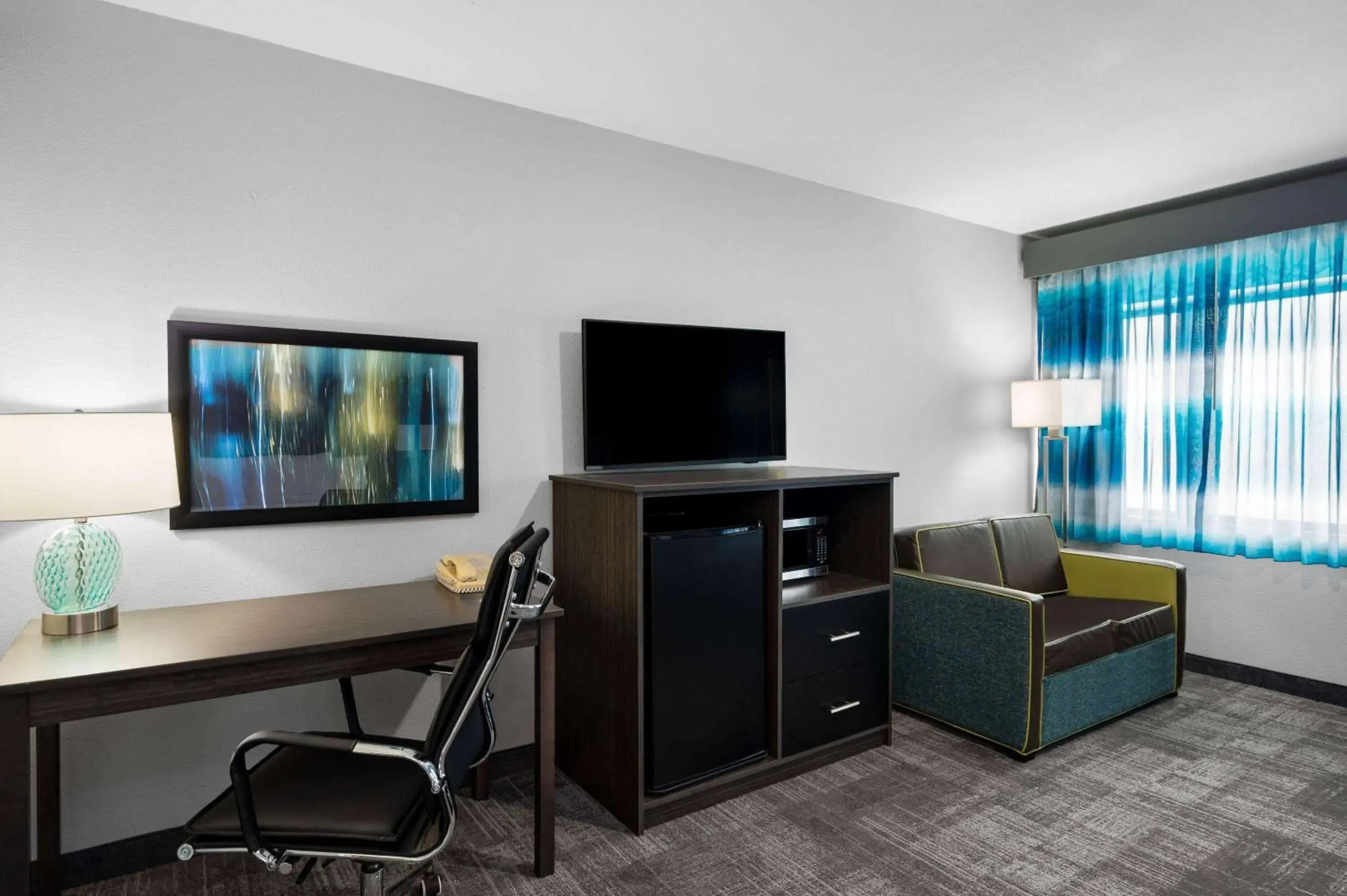 Photo of the whole room, TV/Entertainment Center in La Quinta Inn by Wyndham Indianapolis Airport Executive Dr