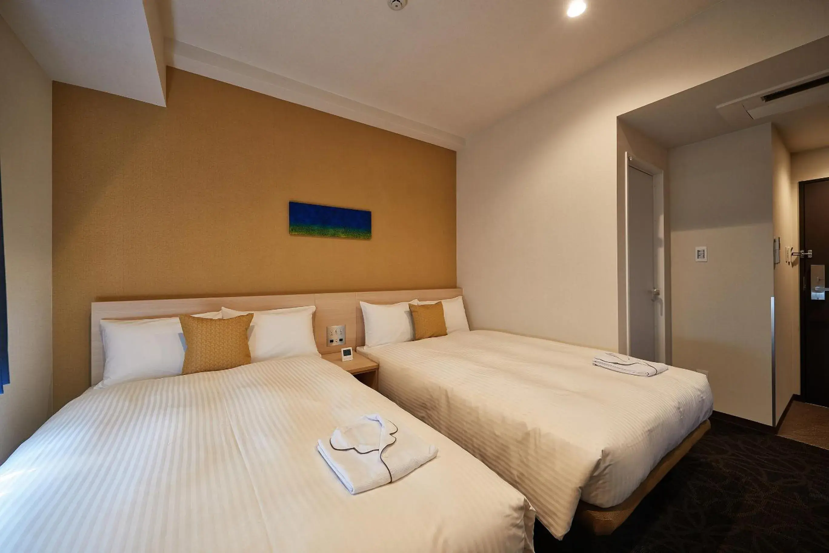 Bed in Y's Inn Naha Oroku Ekimae Bed in Y's Inn Naha Oroku Ekimae