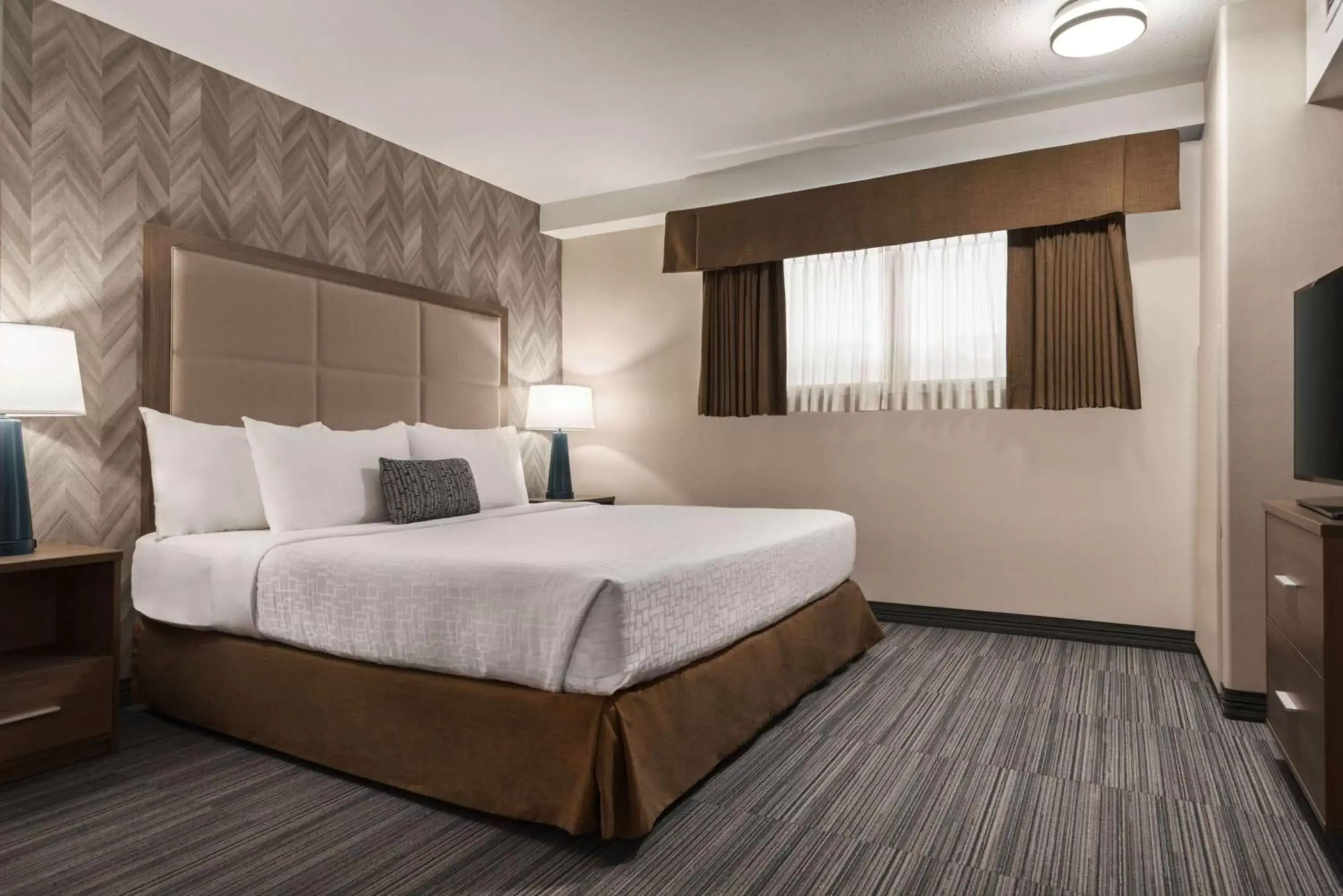 Photo of the whole room, Bed in Ramada by Wyndham Airdrie Hotel & Suites