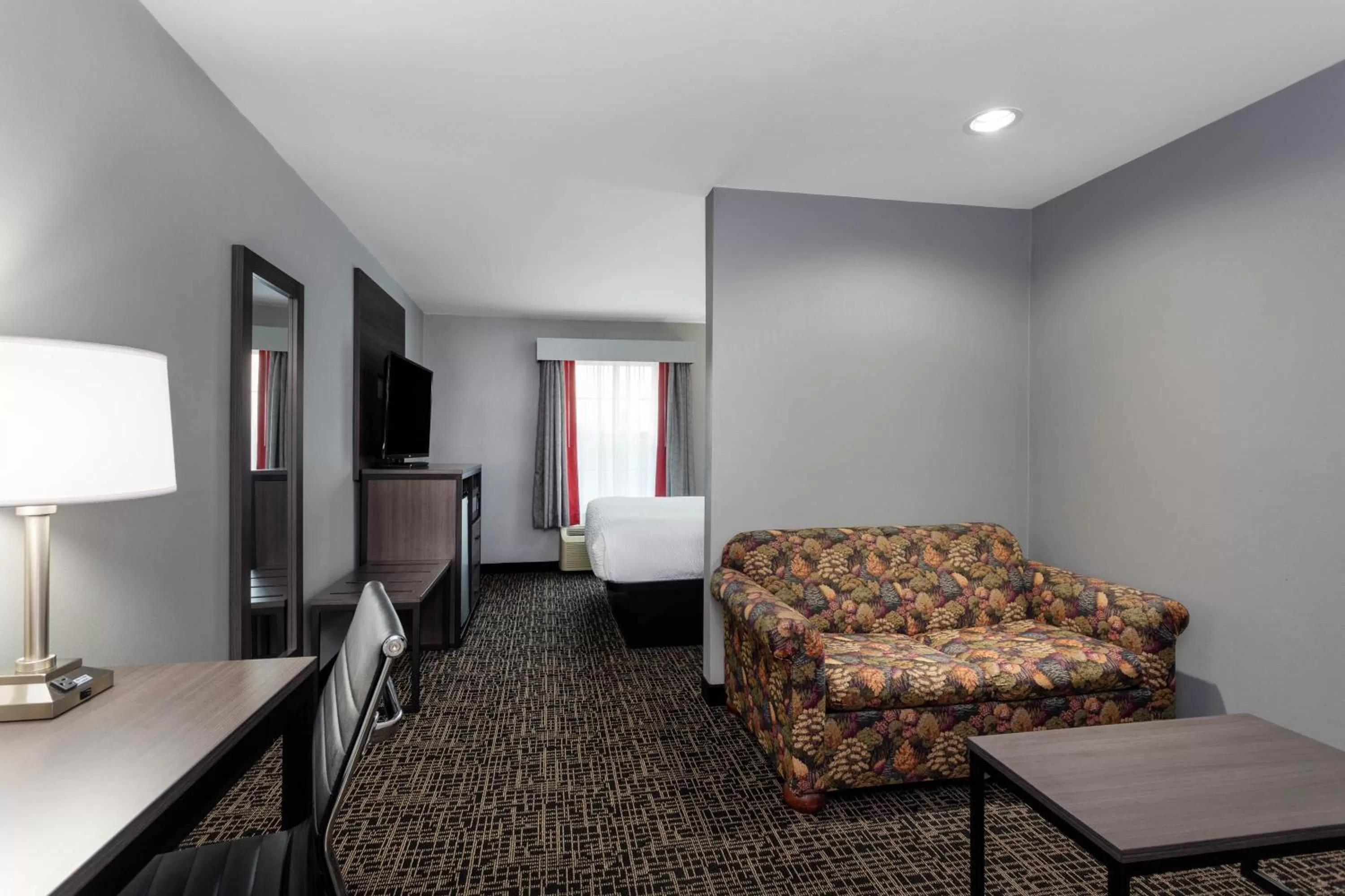 Seating area, Bed in Ramada by Wyndham Sellersburg/Louisville North