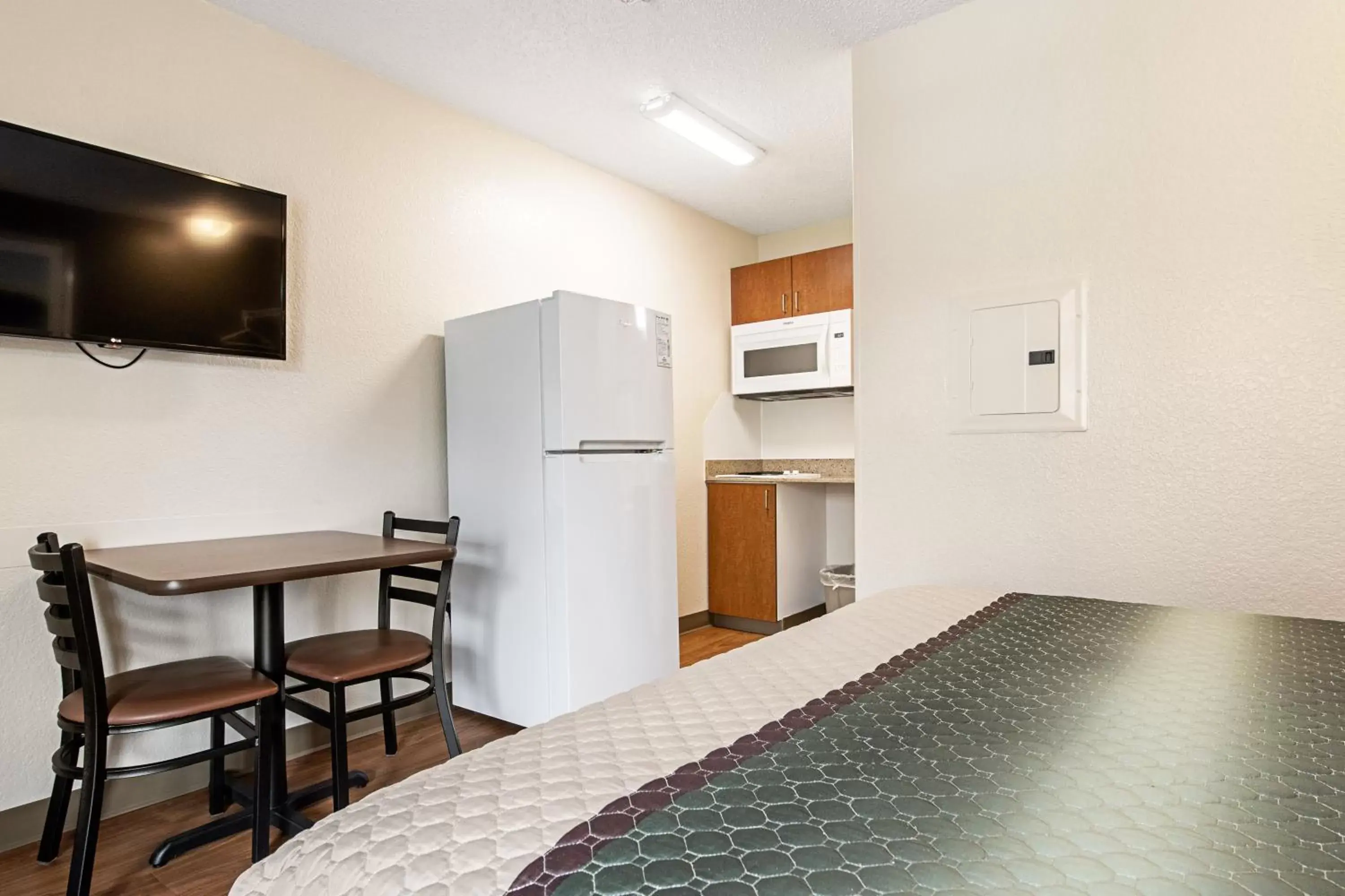 Photo of the whole room, TV/Entertainment Center in HomeTowne Studios by Red Roof Tacoma - Puyallup