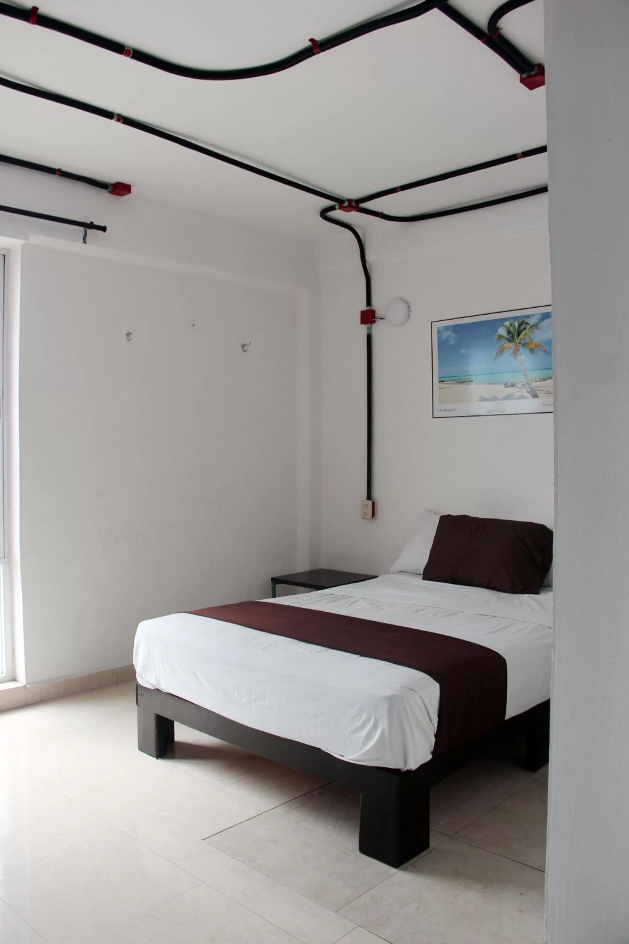 Photo of the whole room, Bed in Hotel & Hostal Casa de Luz Cancun