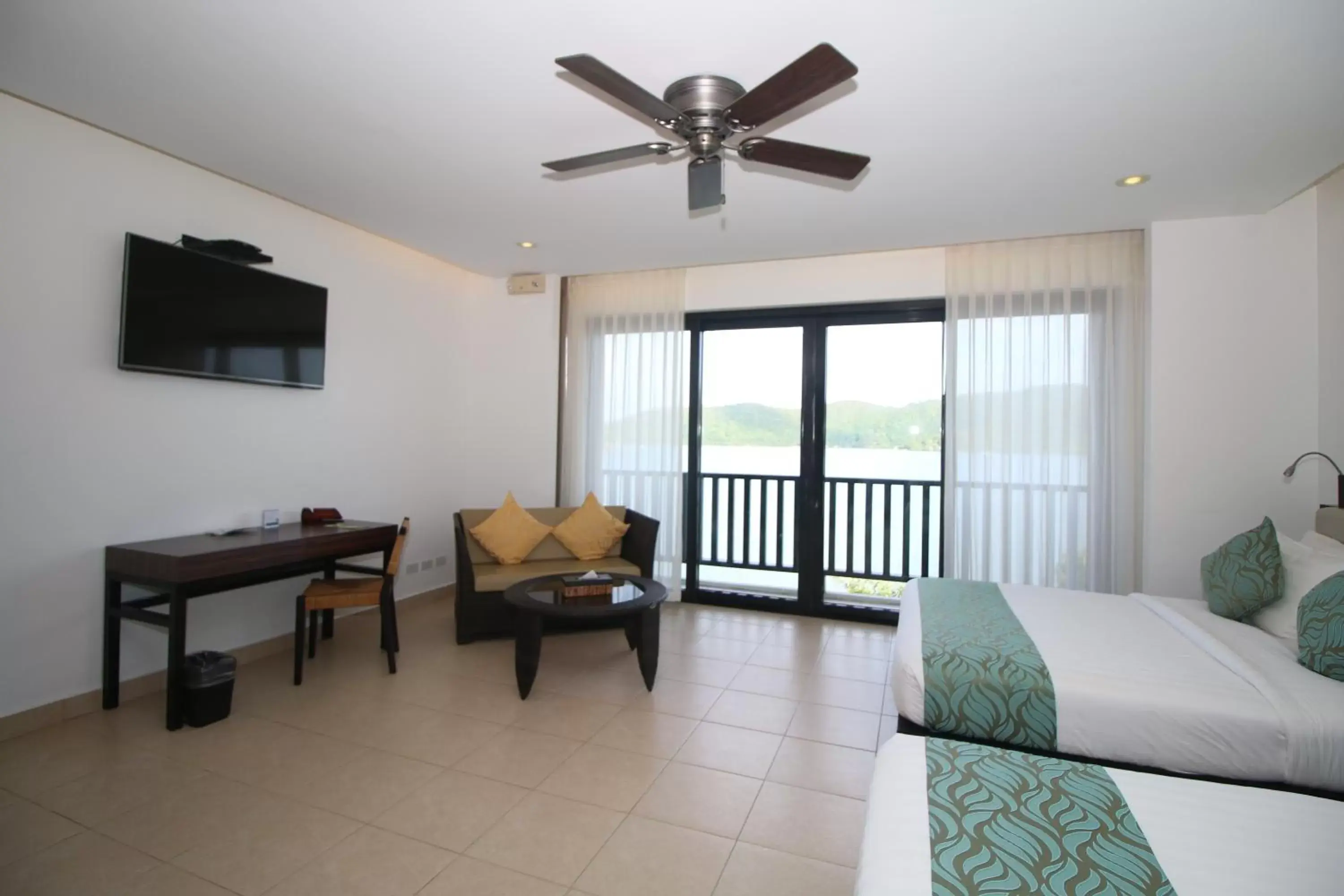 Bed, Seating Area in Busuanga Bay Lodge