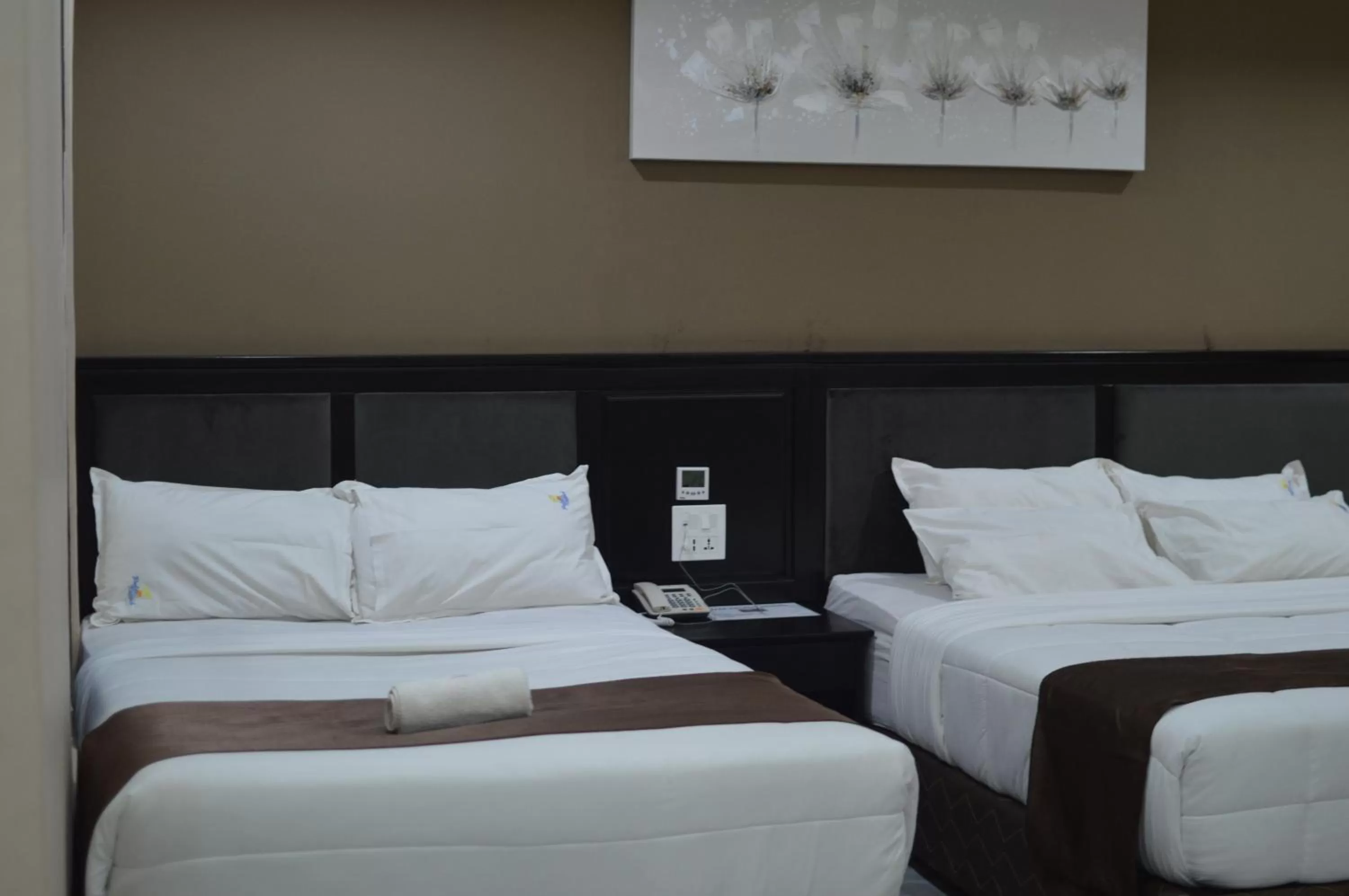 Bed in Palm Kalash Hotel