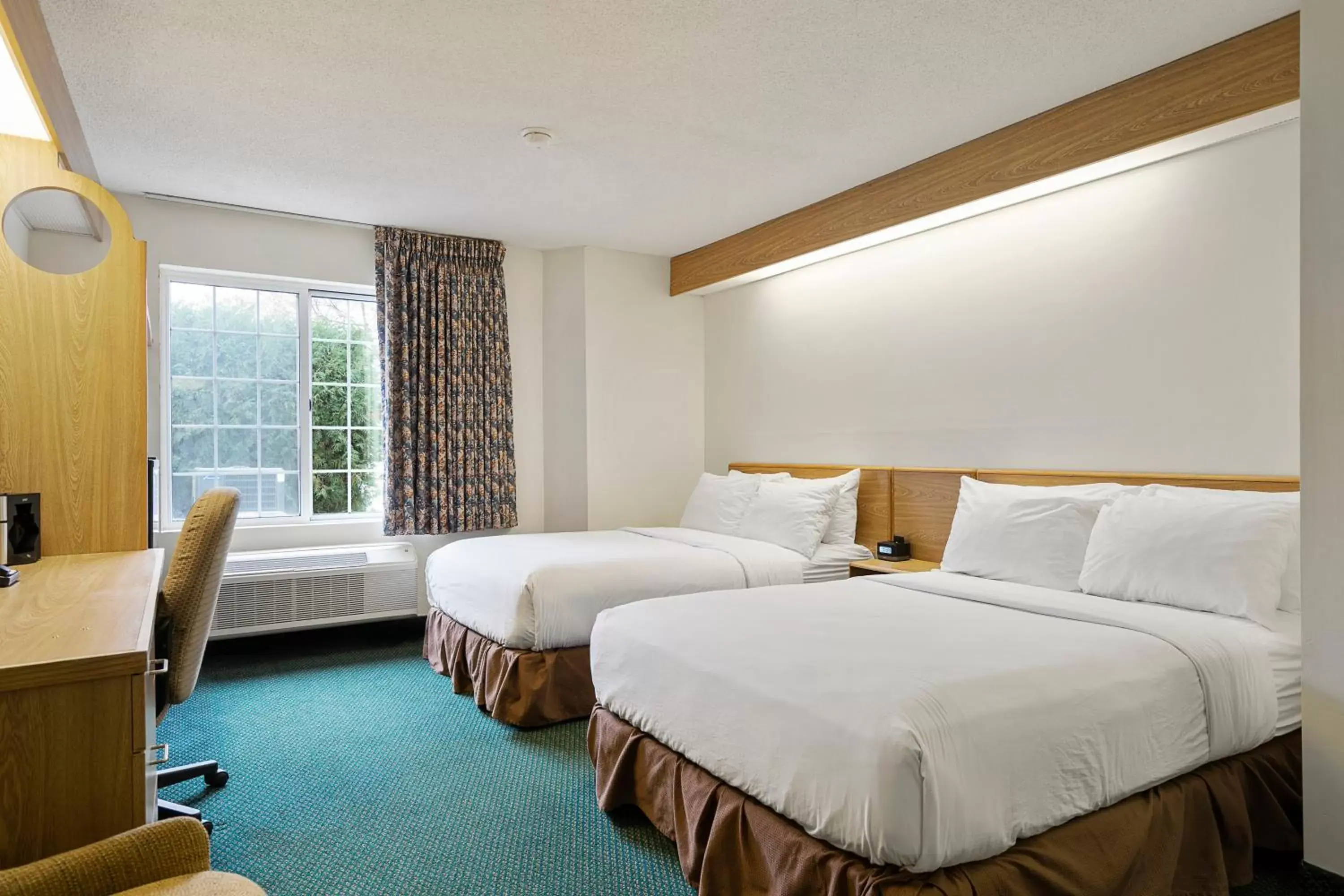 Bed in Charlevoix Inn & Suites SureStay Collection by Best Western