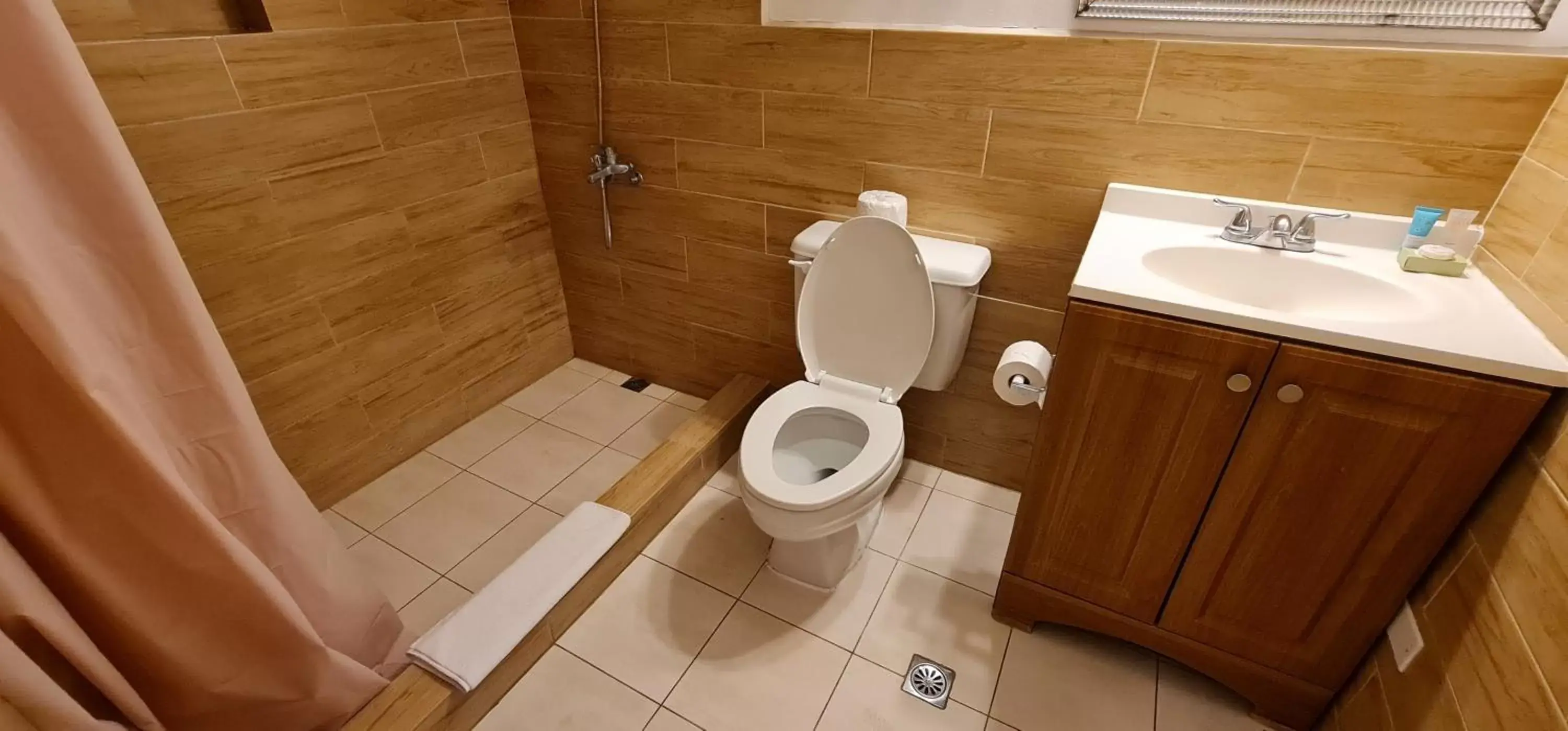 Bathroom in SureStay Hotel by Best Western Guam Palmridge
