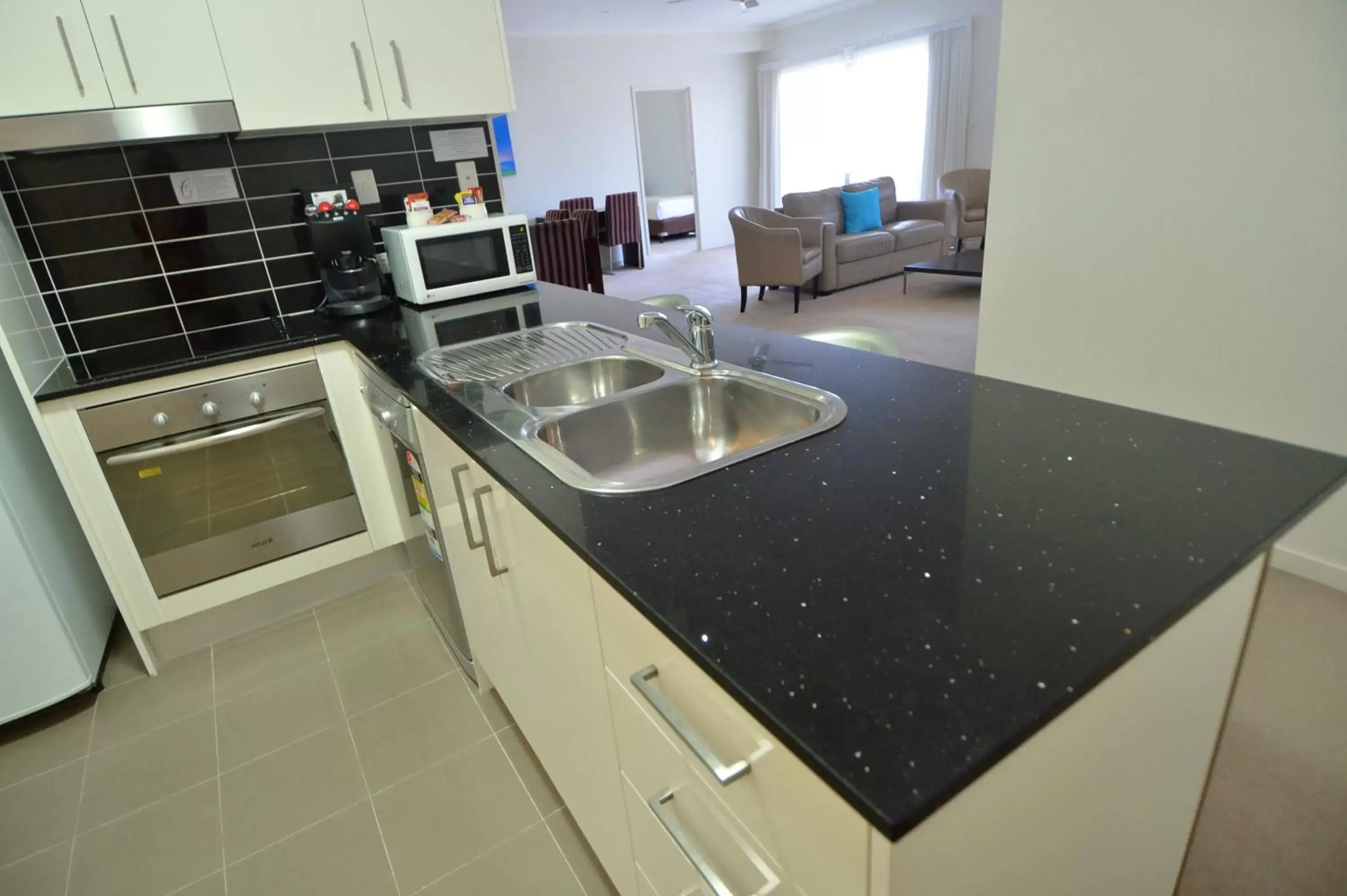 Kitchen or kitchenette, Kitchen/Kitchenette in Gladstone City Central Apartment Hotel