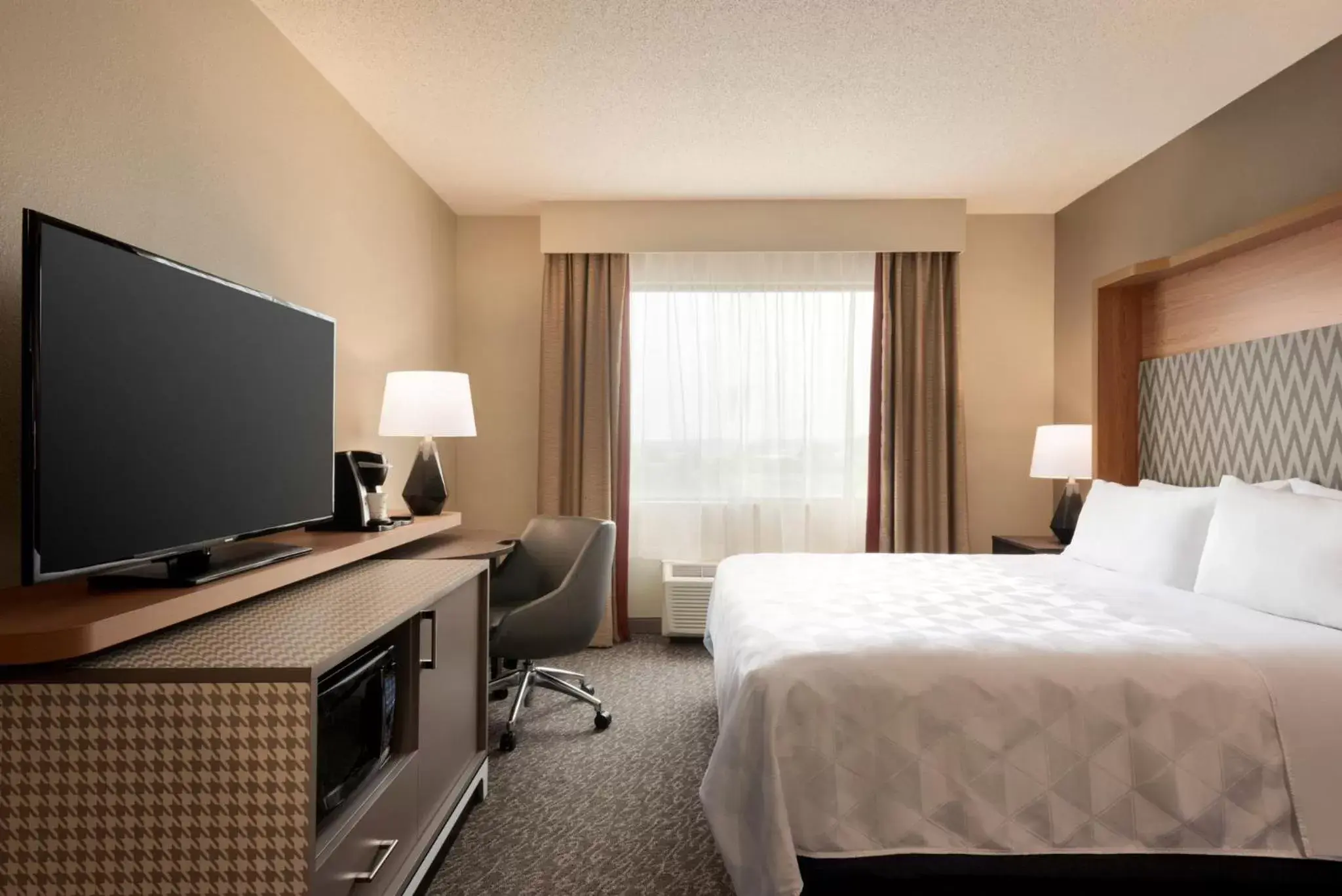 Photo of the whole room, TV/Entertainment Center in Holiday Inn Hotel & Suites Council Bluffs, an IHG Hotel