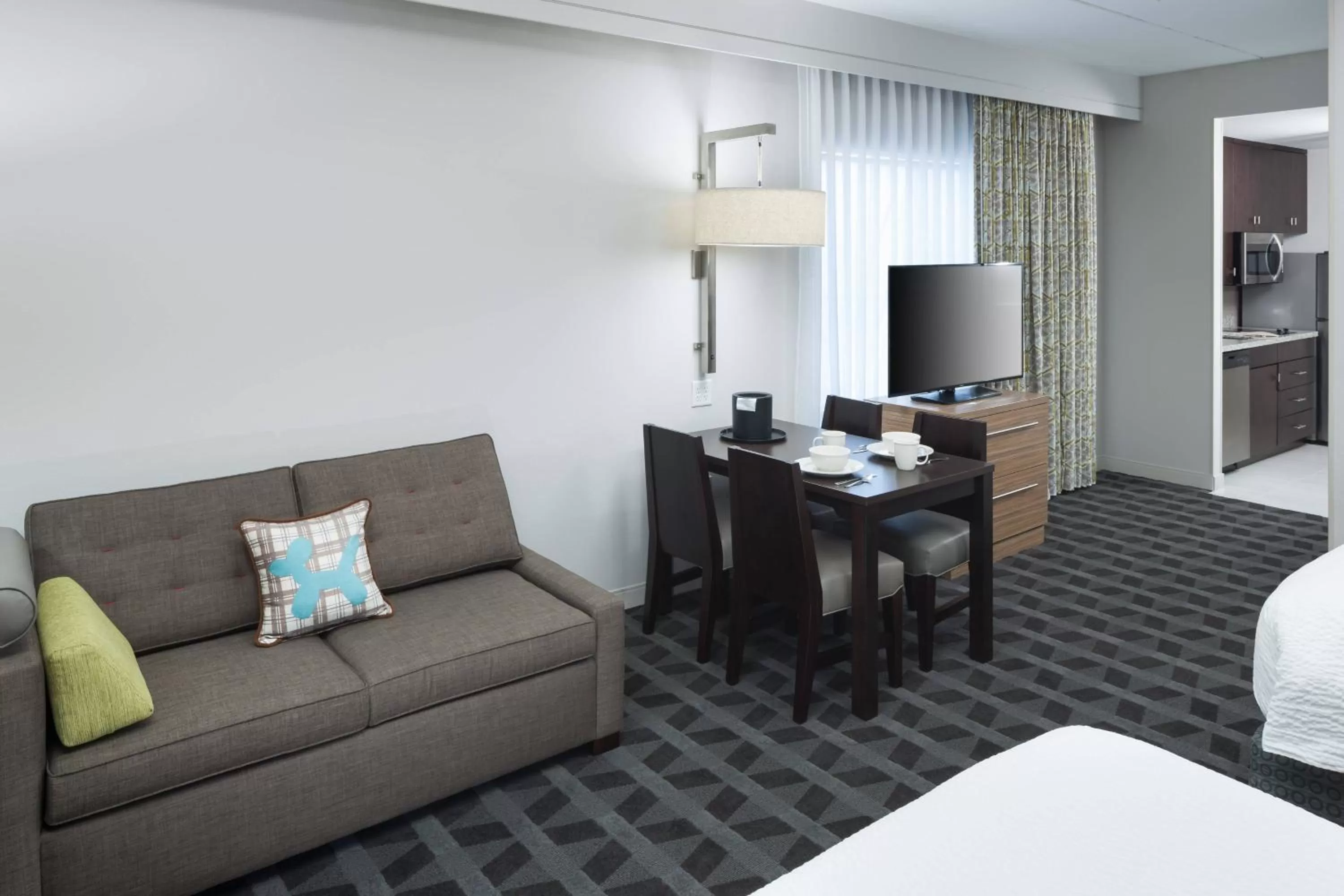 Living room, Bed in TownePlace Suites by Marriott Orlando at SeaWorld