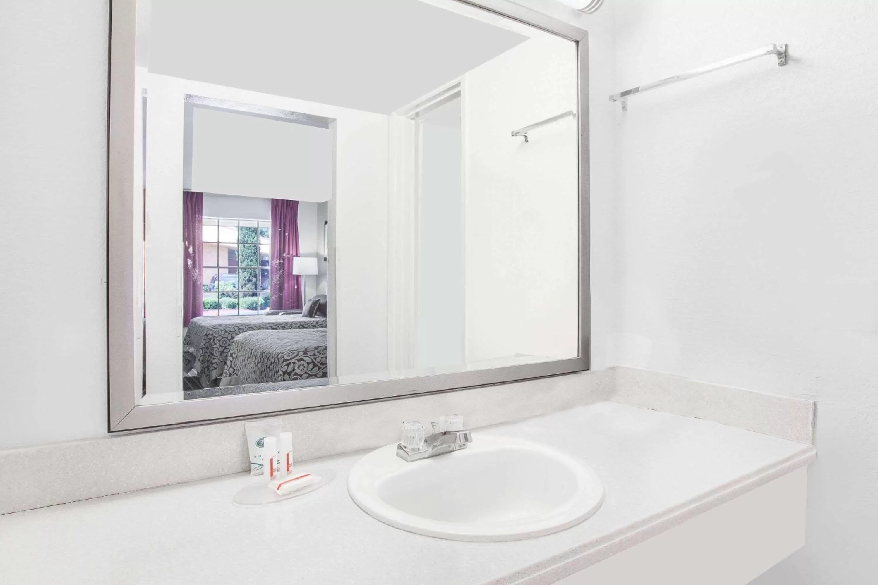 Bathroom in Days Inn by Wyndham Market Center Dallas Love Field