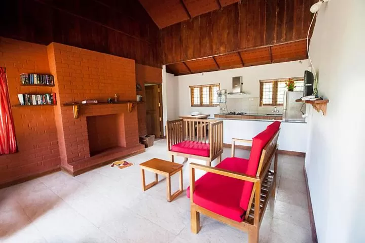 Living room, Kitchen/Kitchenette in Marmalade Springs Resort Wayanad