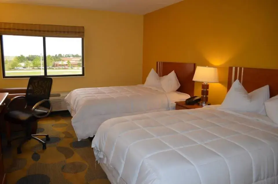 Bed in Marble Waters Hotel & Suites, Trademark by Wyndham Bed in Marble Waters Hotel & Suites, Trademark by Wyndham