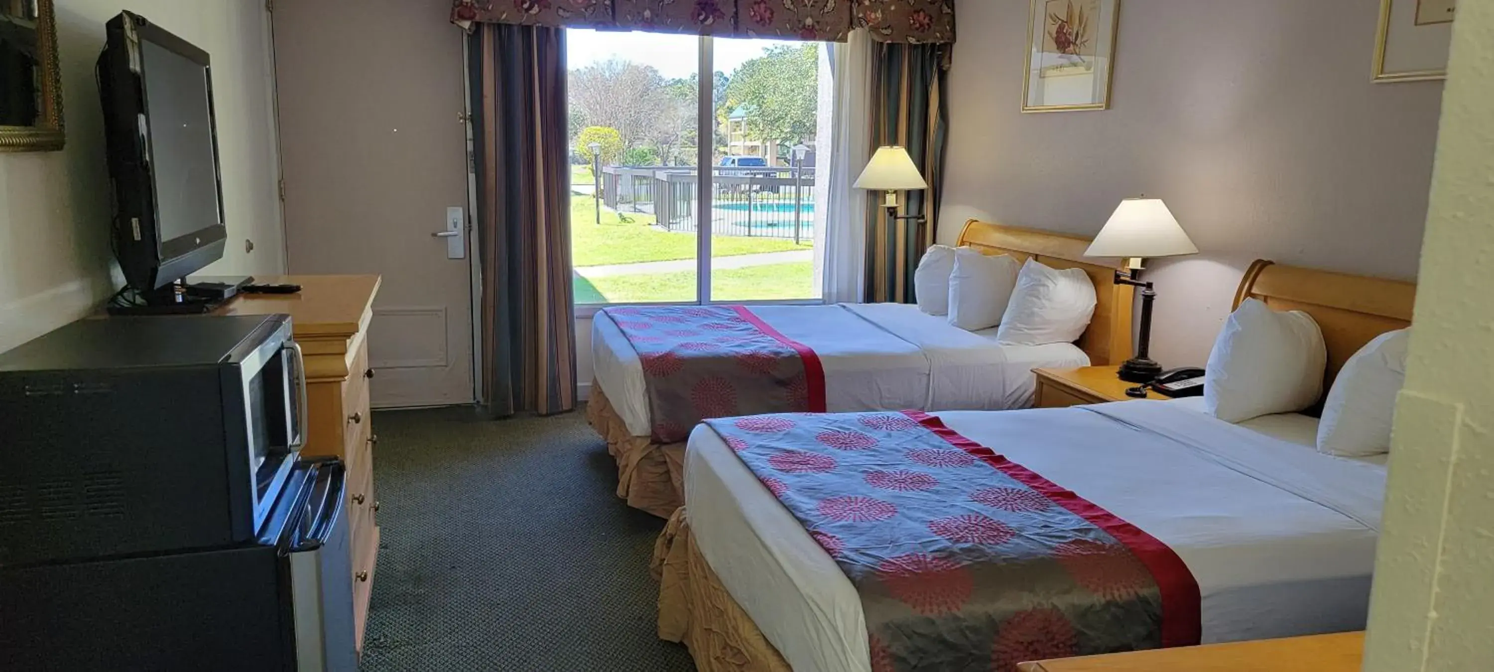 Bed in Ramada by Wyndham & Suites Warner Robins