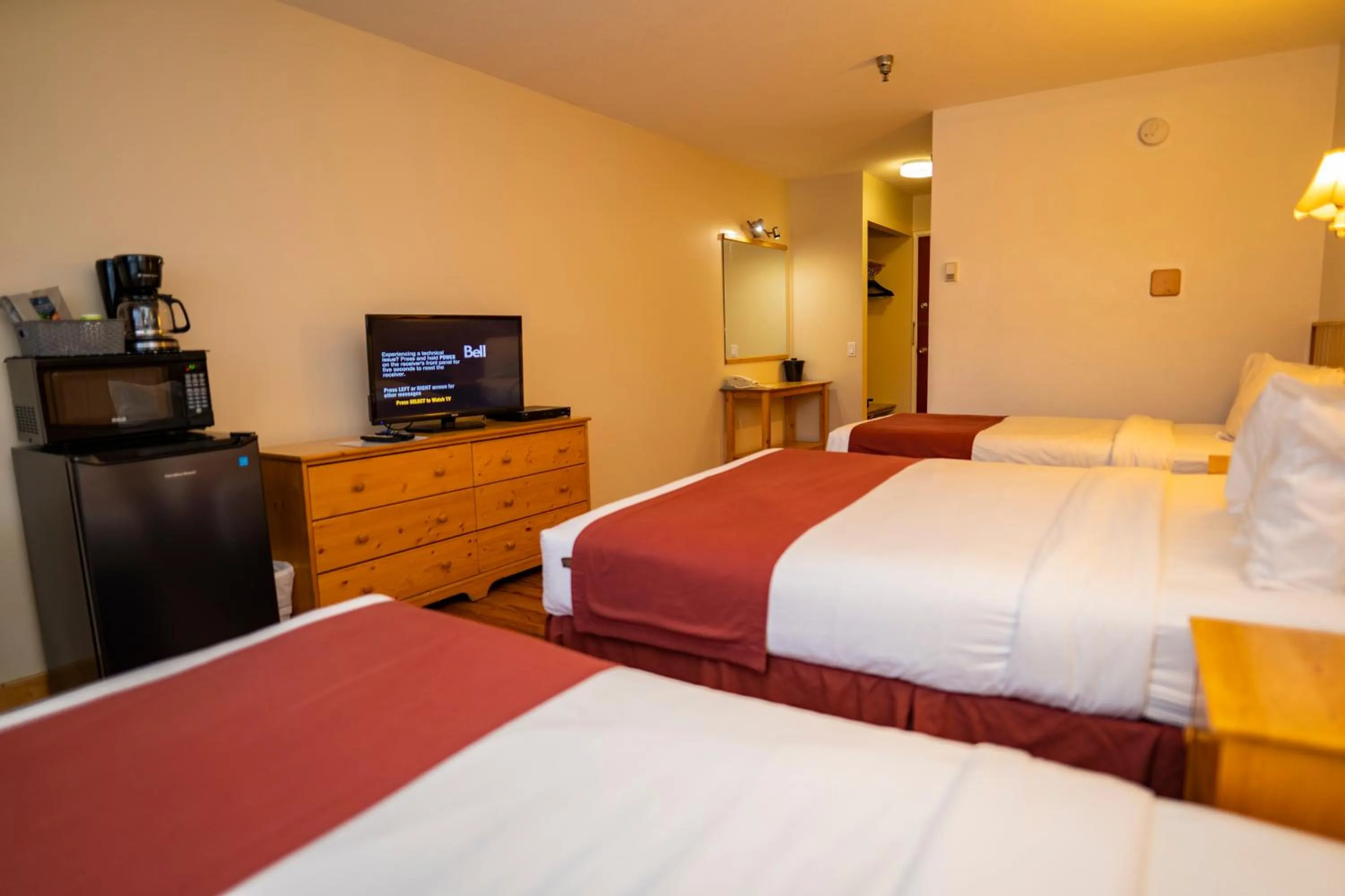 Bed in Canadas Best Value Inn- Riverview Hotel
