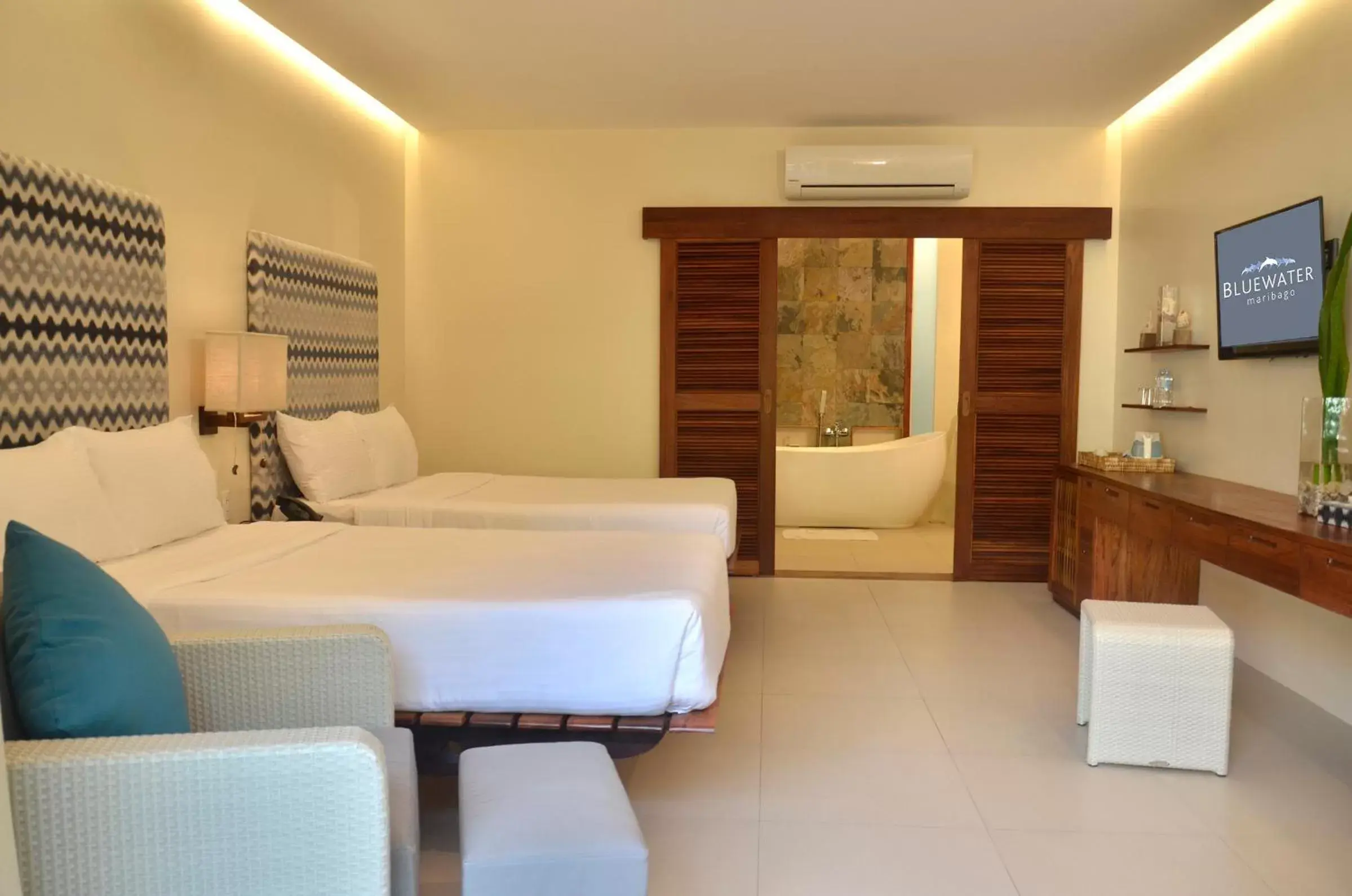 Bed in Bluewater Maribago Beach Resort