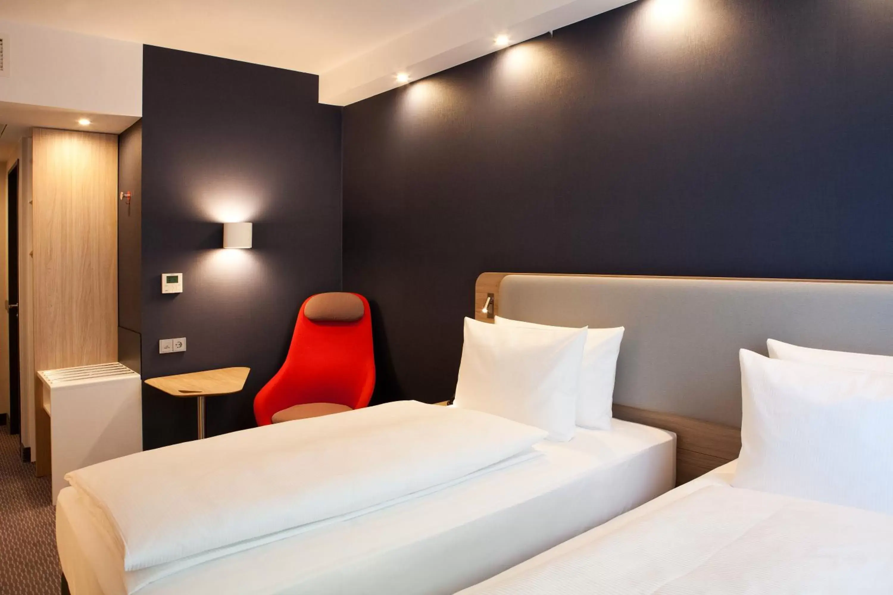Bedroom, Bed in Holiday Inn Express & Suites - Basel - Allschwil, an IHG Hotel