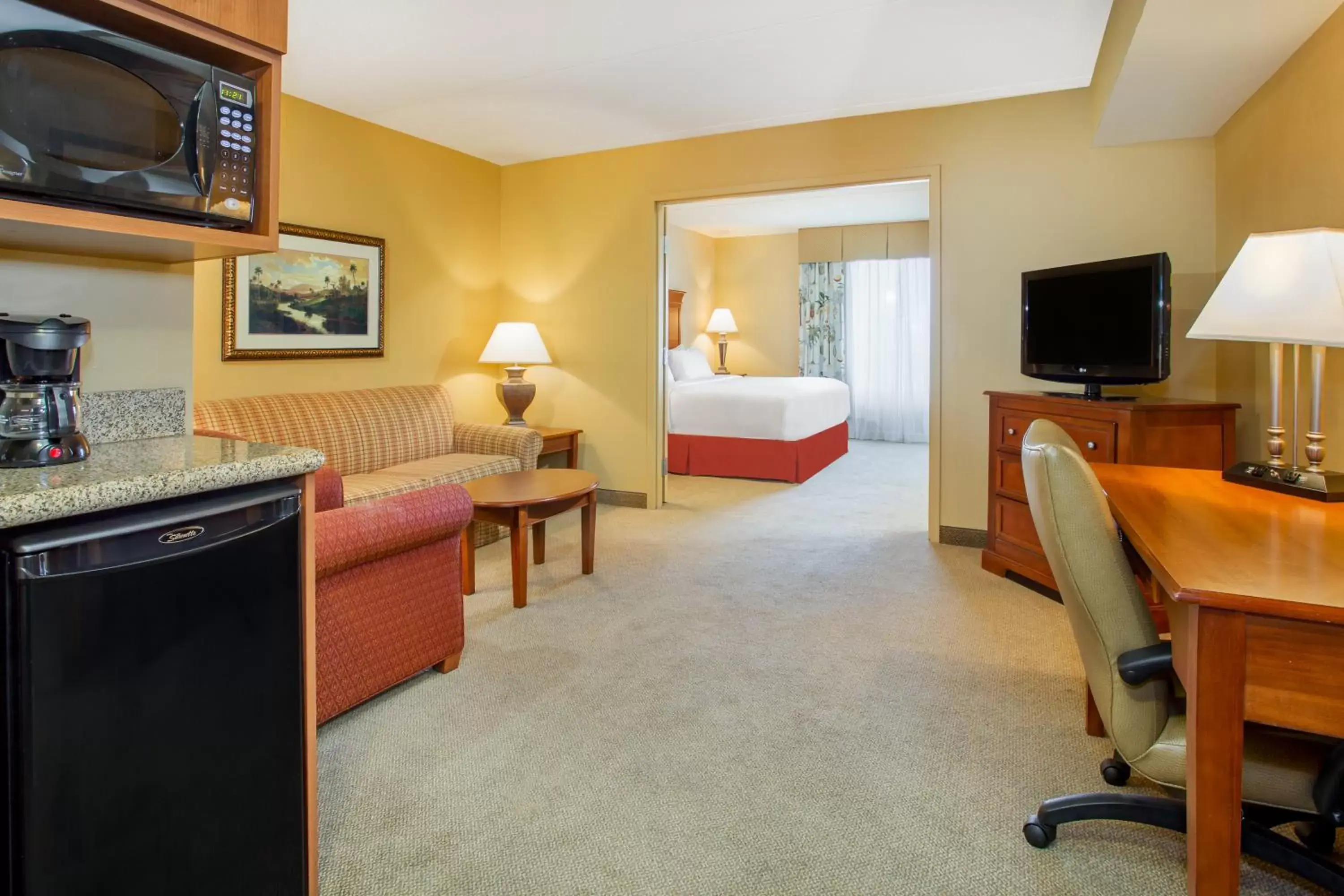 Photo of the whole room, TV/Entertainment Center in Holiday Inn Express & Suites Bloomington, an IHG Hotel