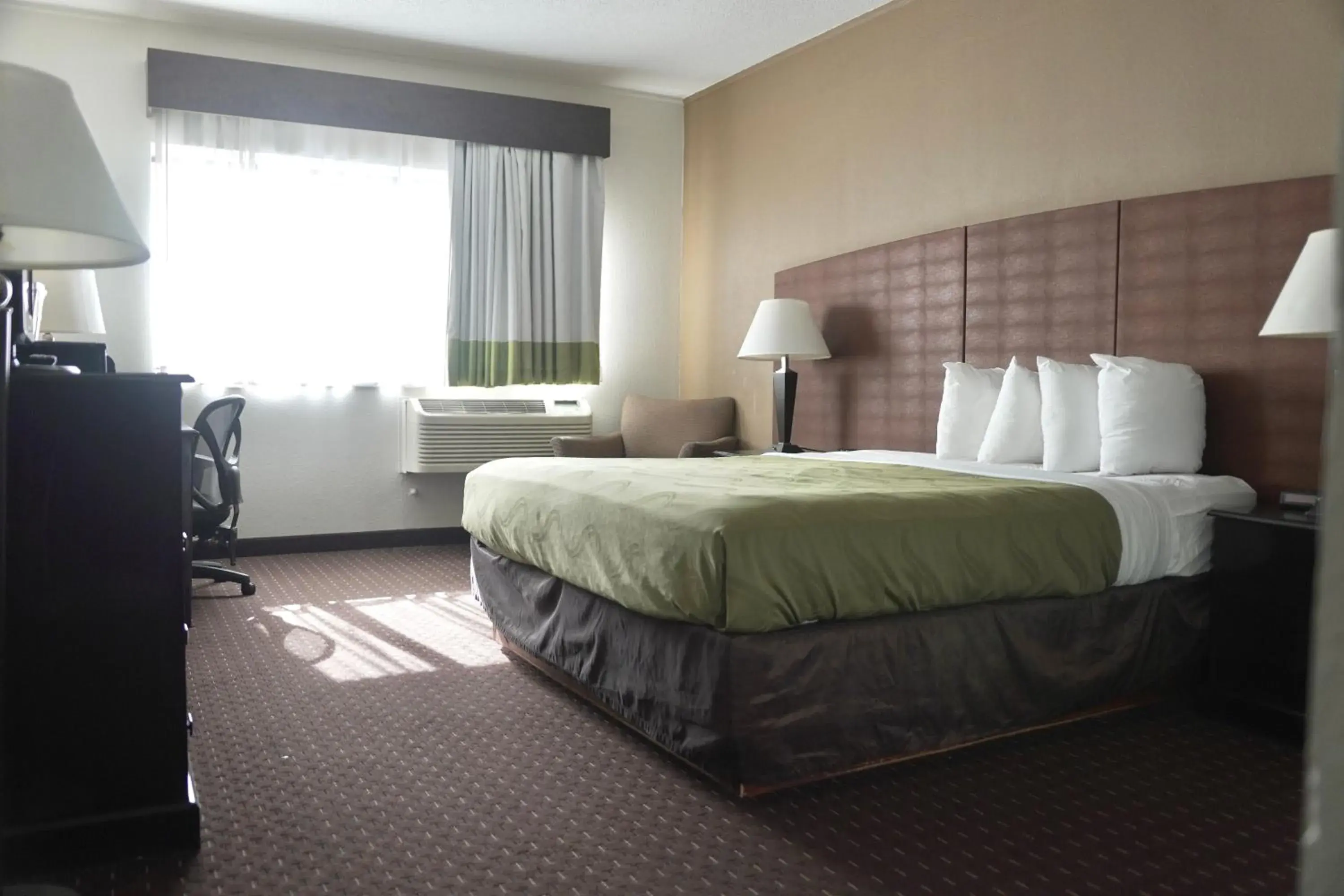 Bed in American Inn & Suites