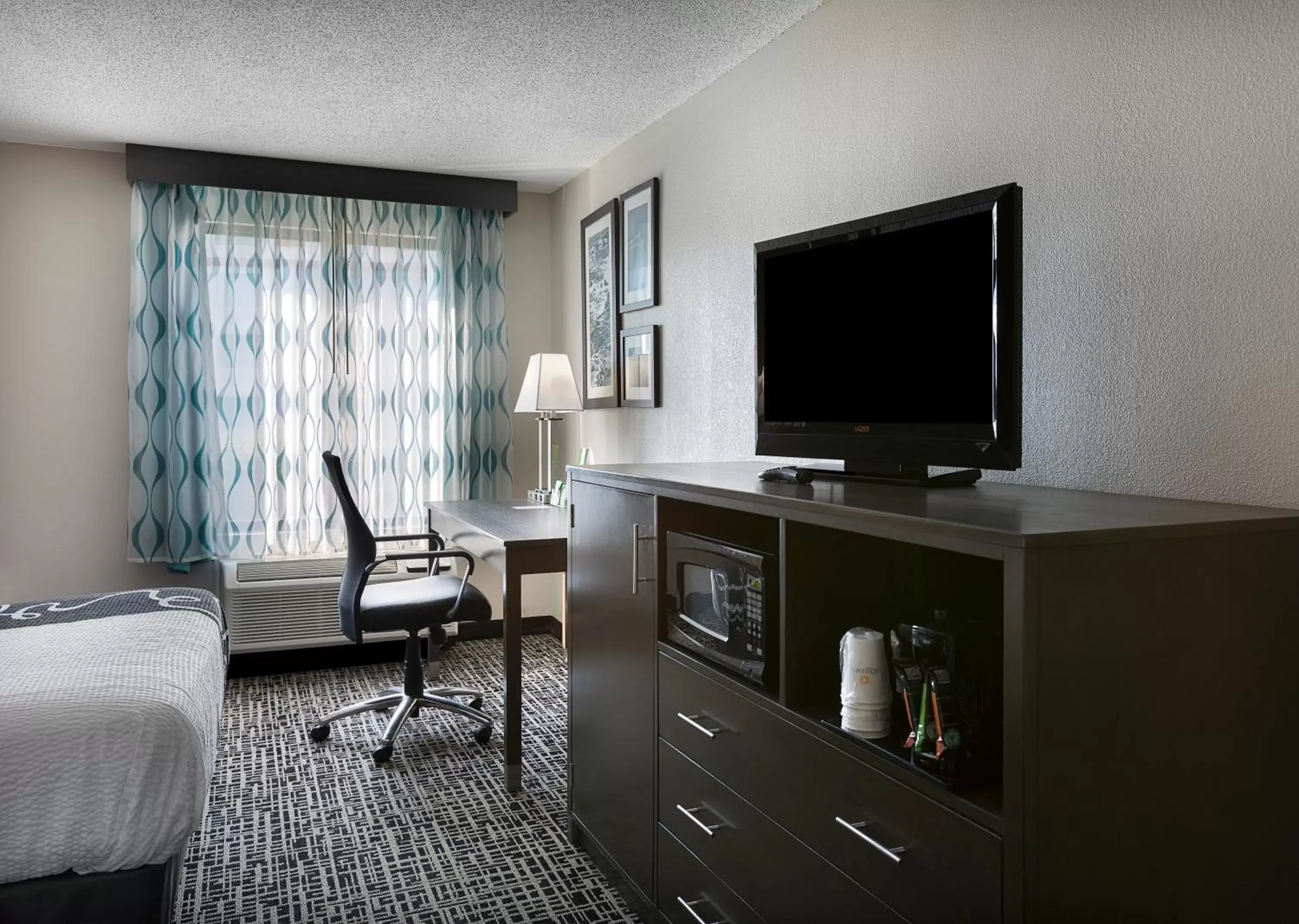 Photo of the whole room, TV/Entertainment Center in La Quinta Inn by Wyndham North Myrtle Beach