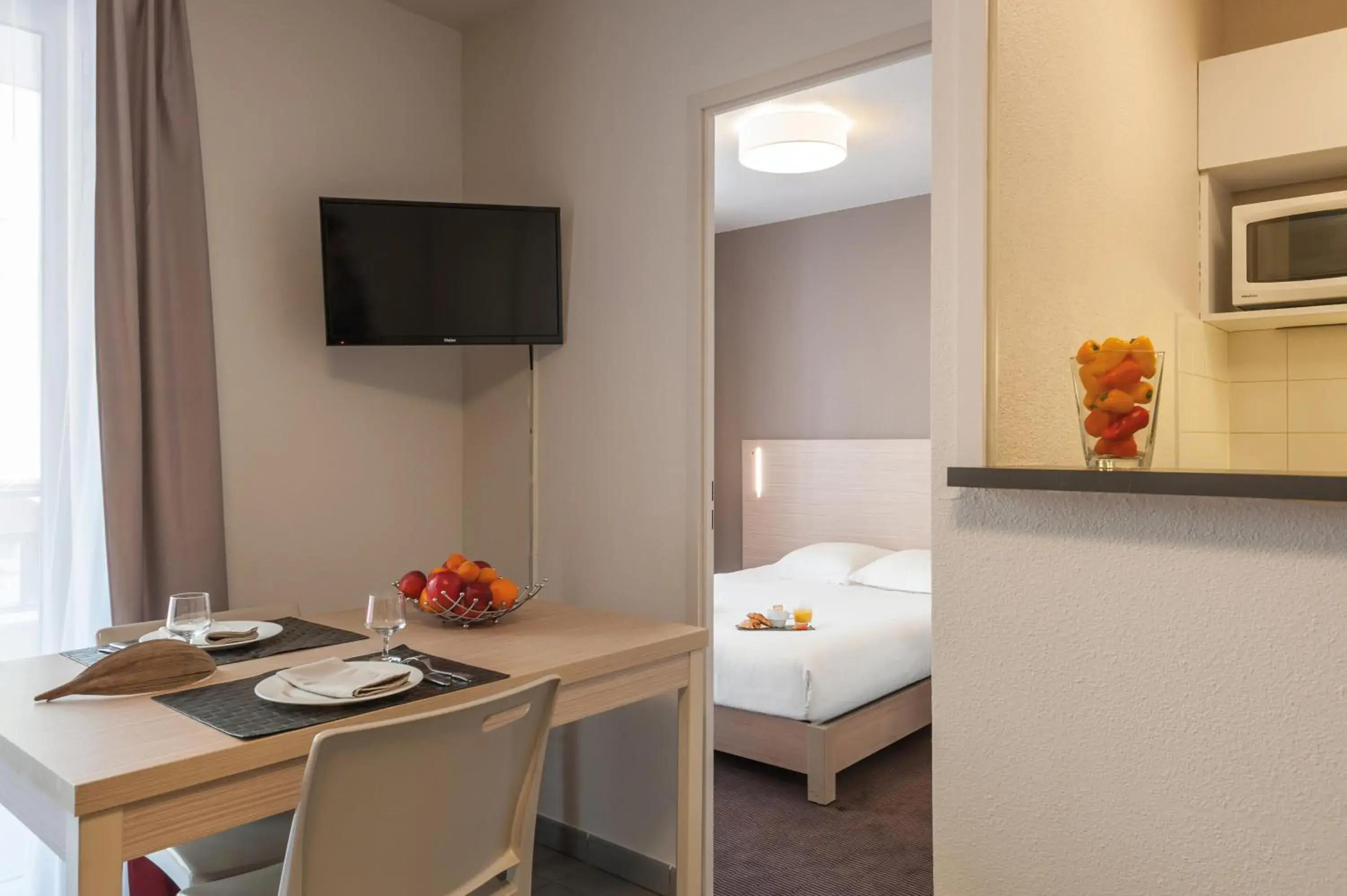 Bed, Dining Area in Appart'City Lyon Part Dieu Garibaldi
