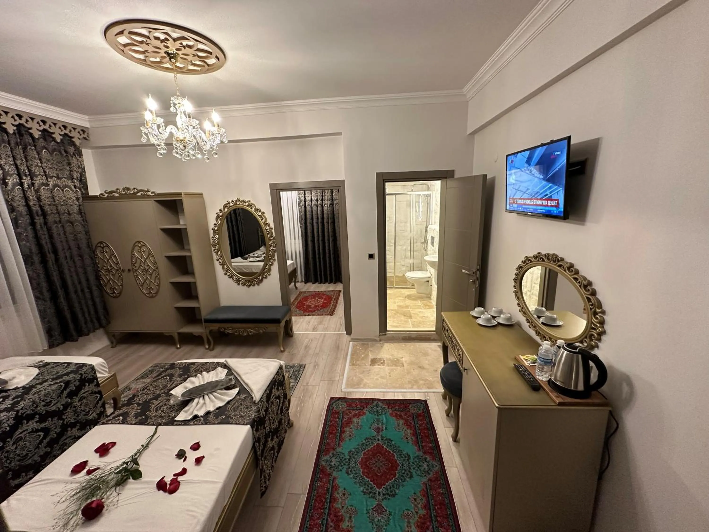 Bed, TV/Entertainment Center in Ethnica Suites