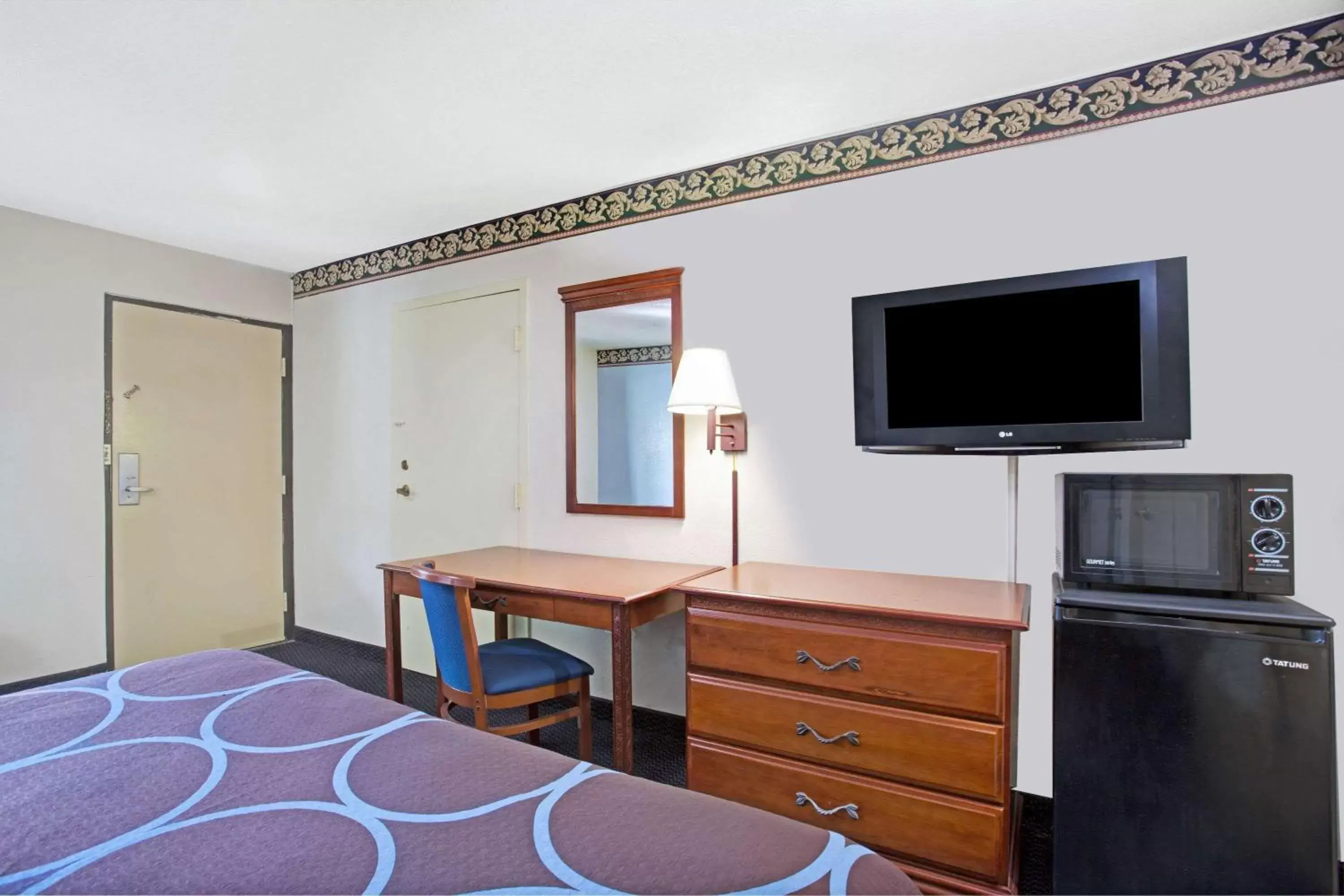 Photo of the whole room, TV/Entertainment Center in Super 8 by Wyndham Suwanee