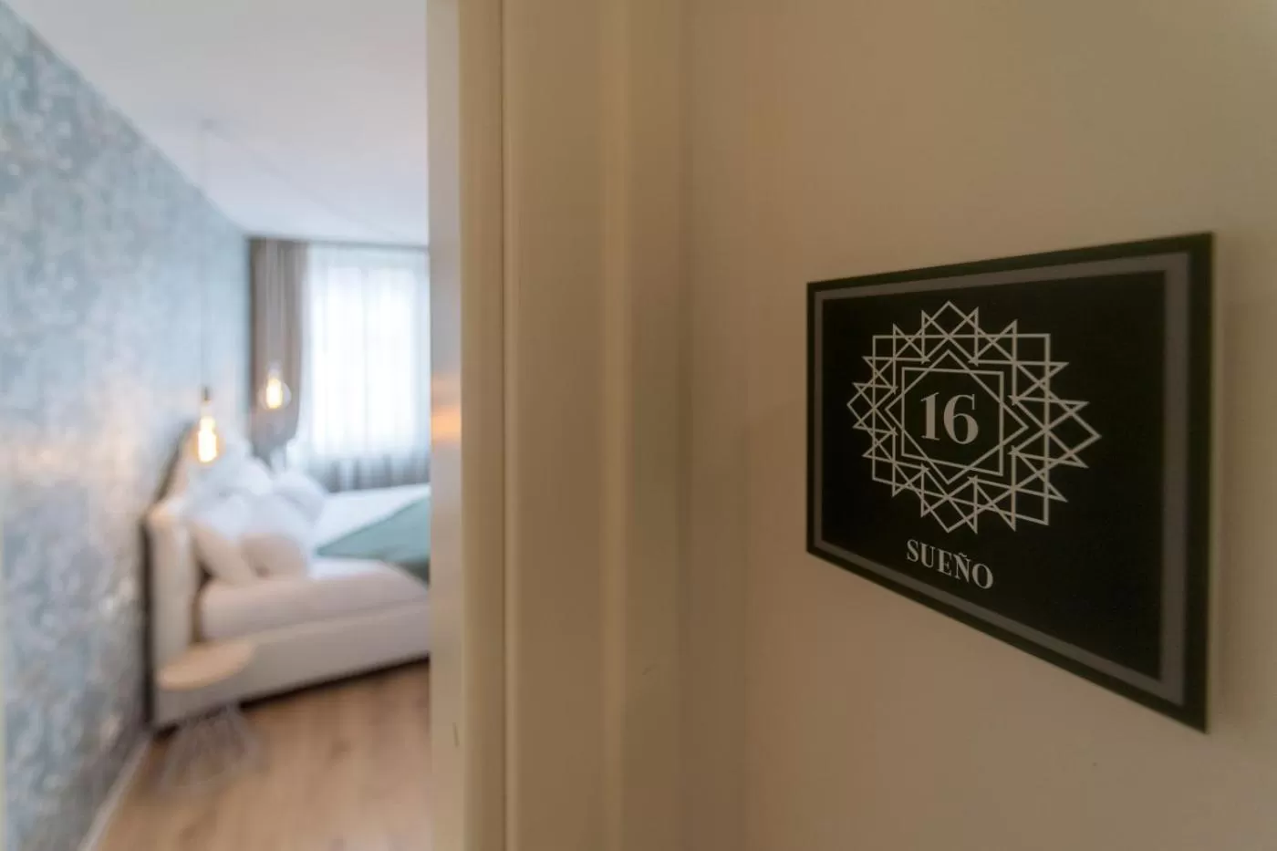 Property logo or sign, Bed in Lainez Rooms & Suites