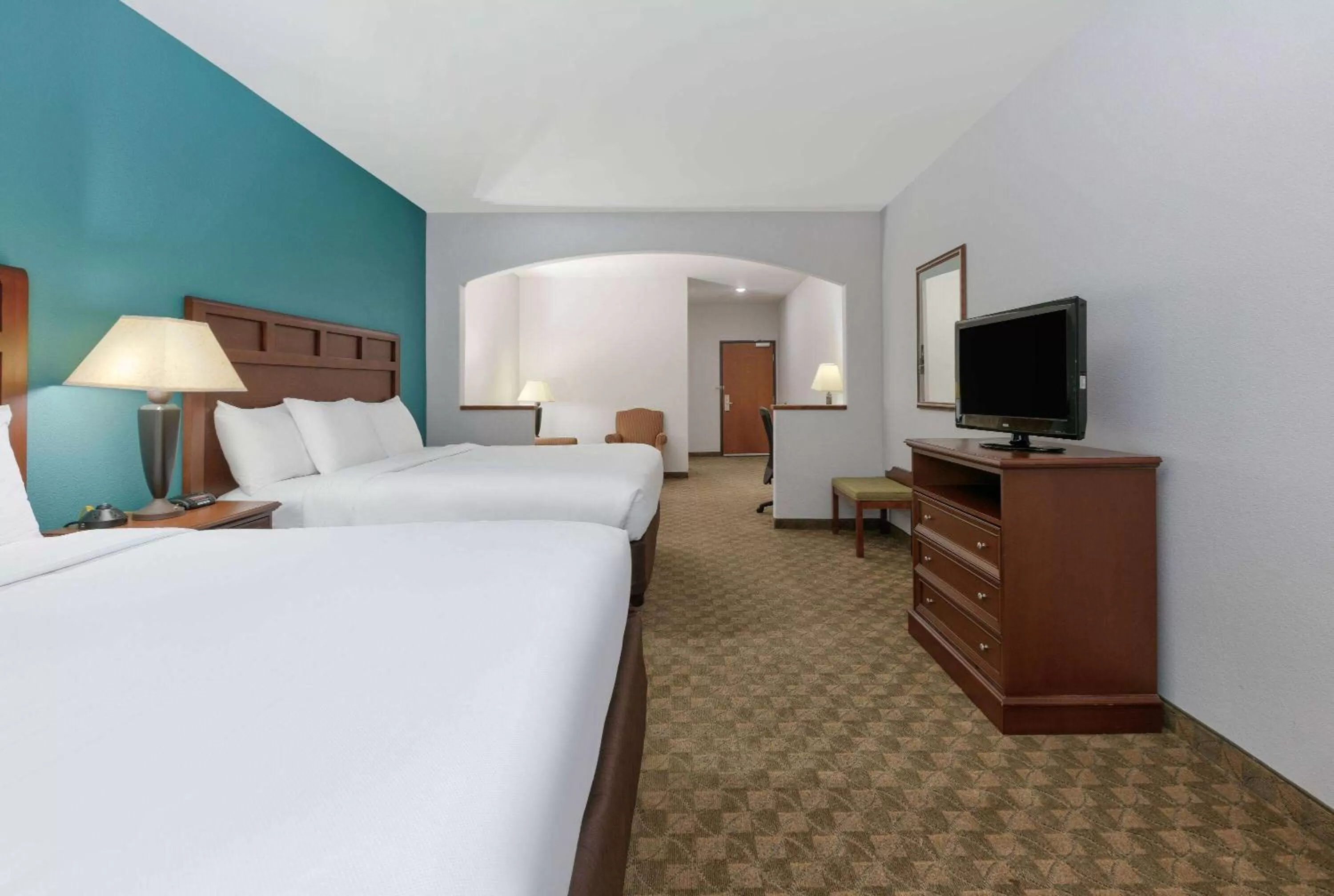 Bed in Baymont Inn & Suites by Wyndham Glen Rose