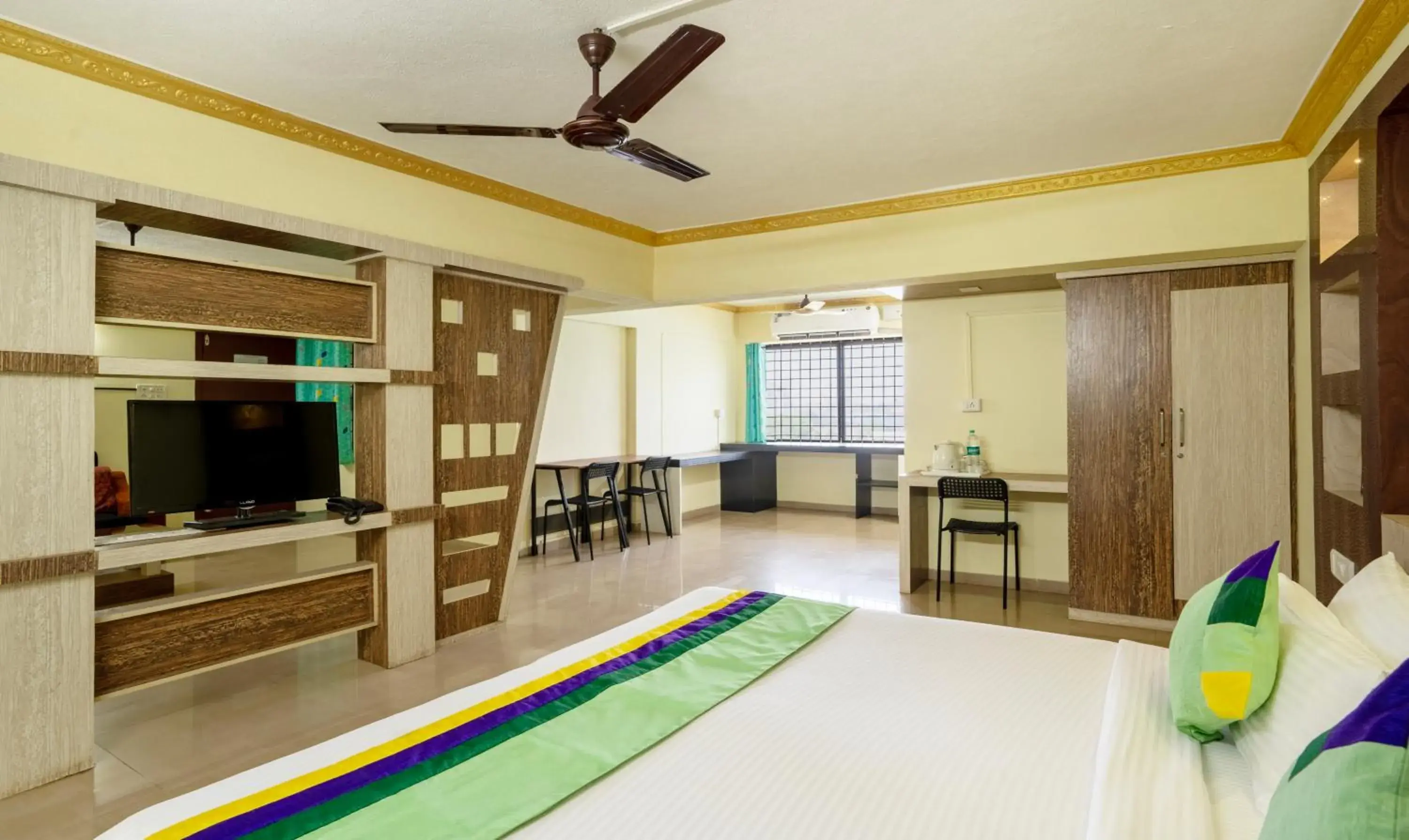 Bed, TV/Entertainment Center in Hotel Vijaya Residency