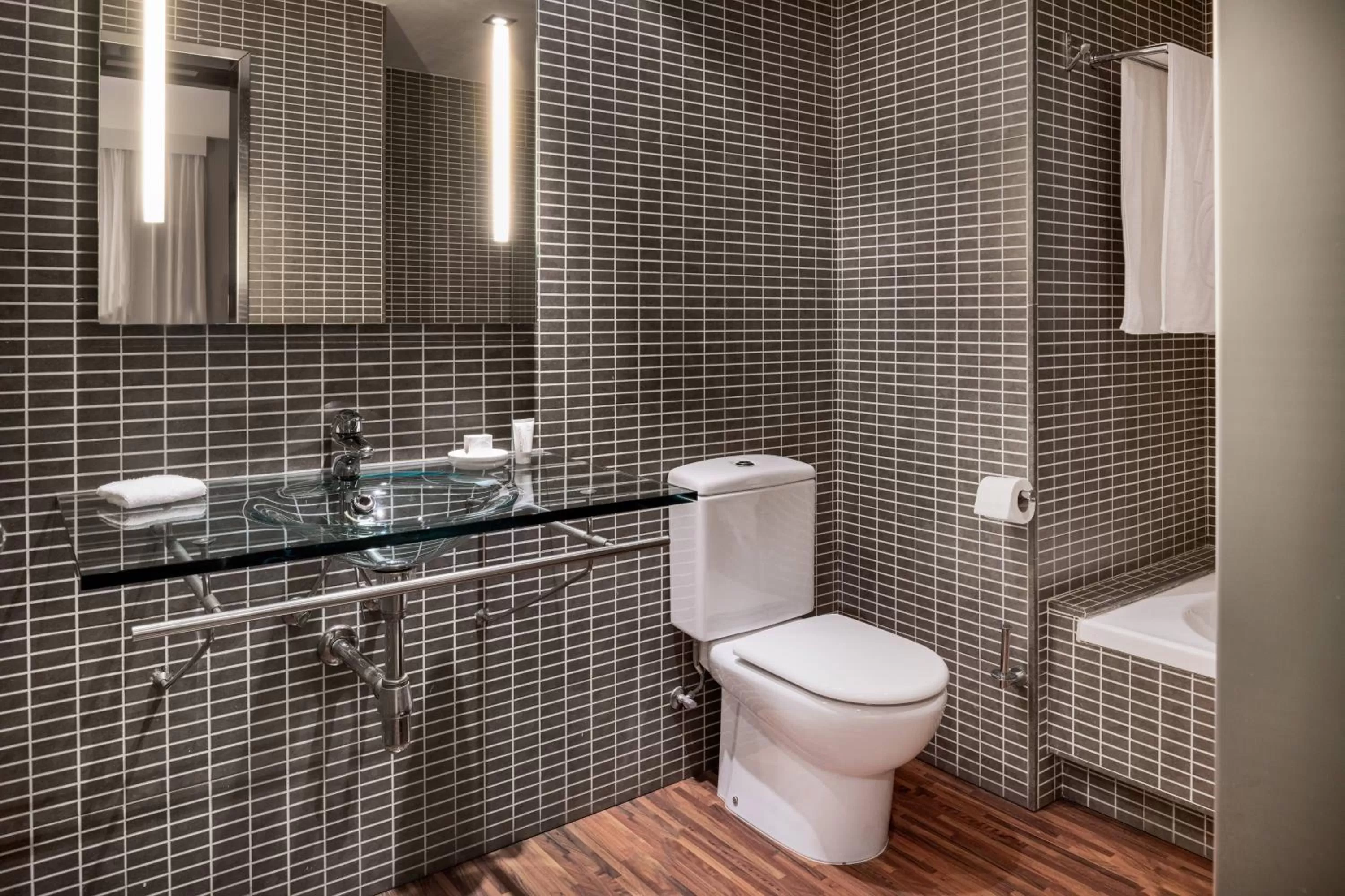 Bathroom in AC Hotel Palacio Universal by Marriott