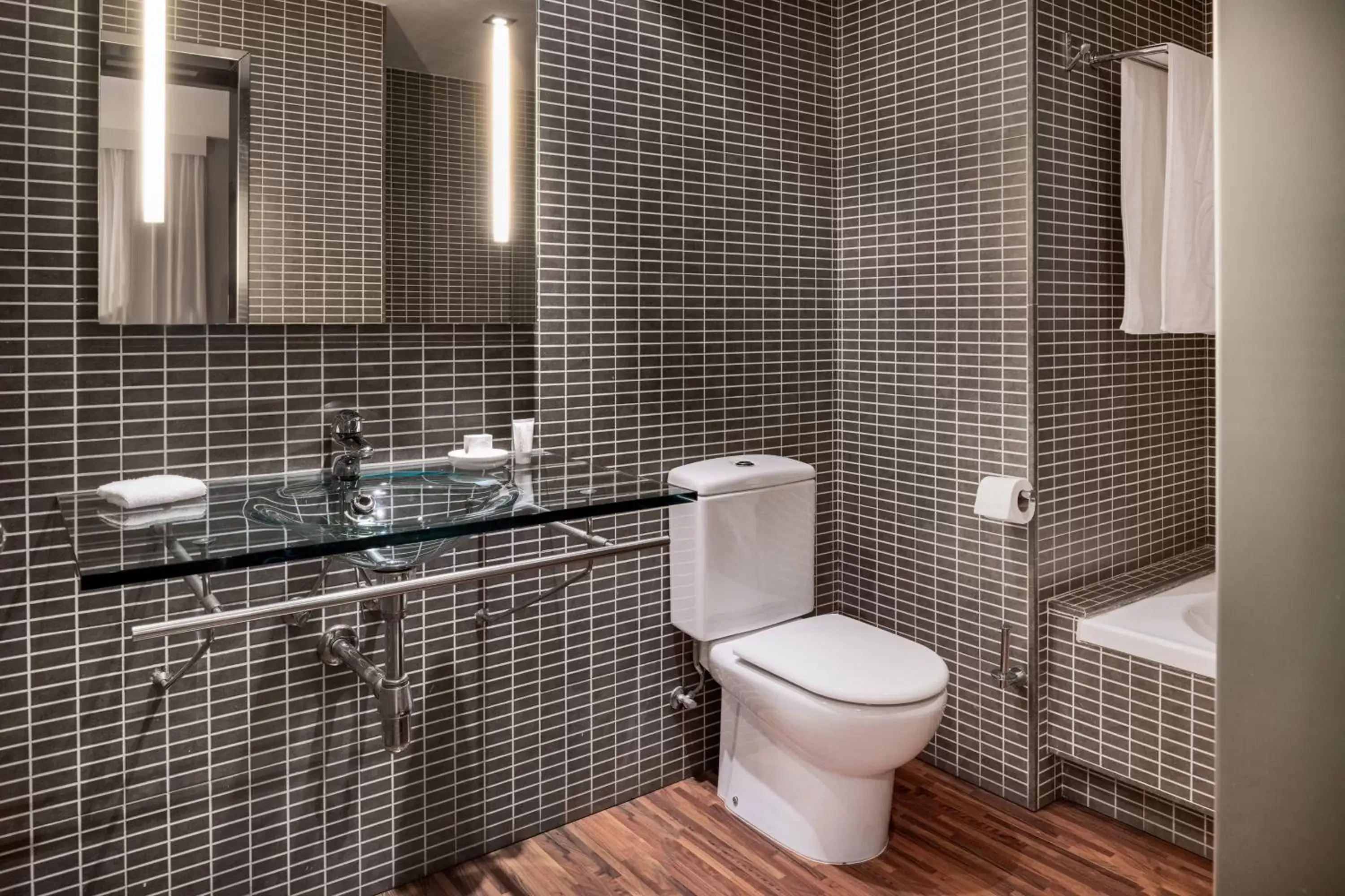 Bathroom in AC Hotel Palacio Universal by Marriott