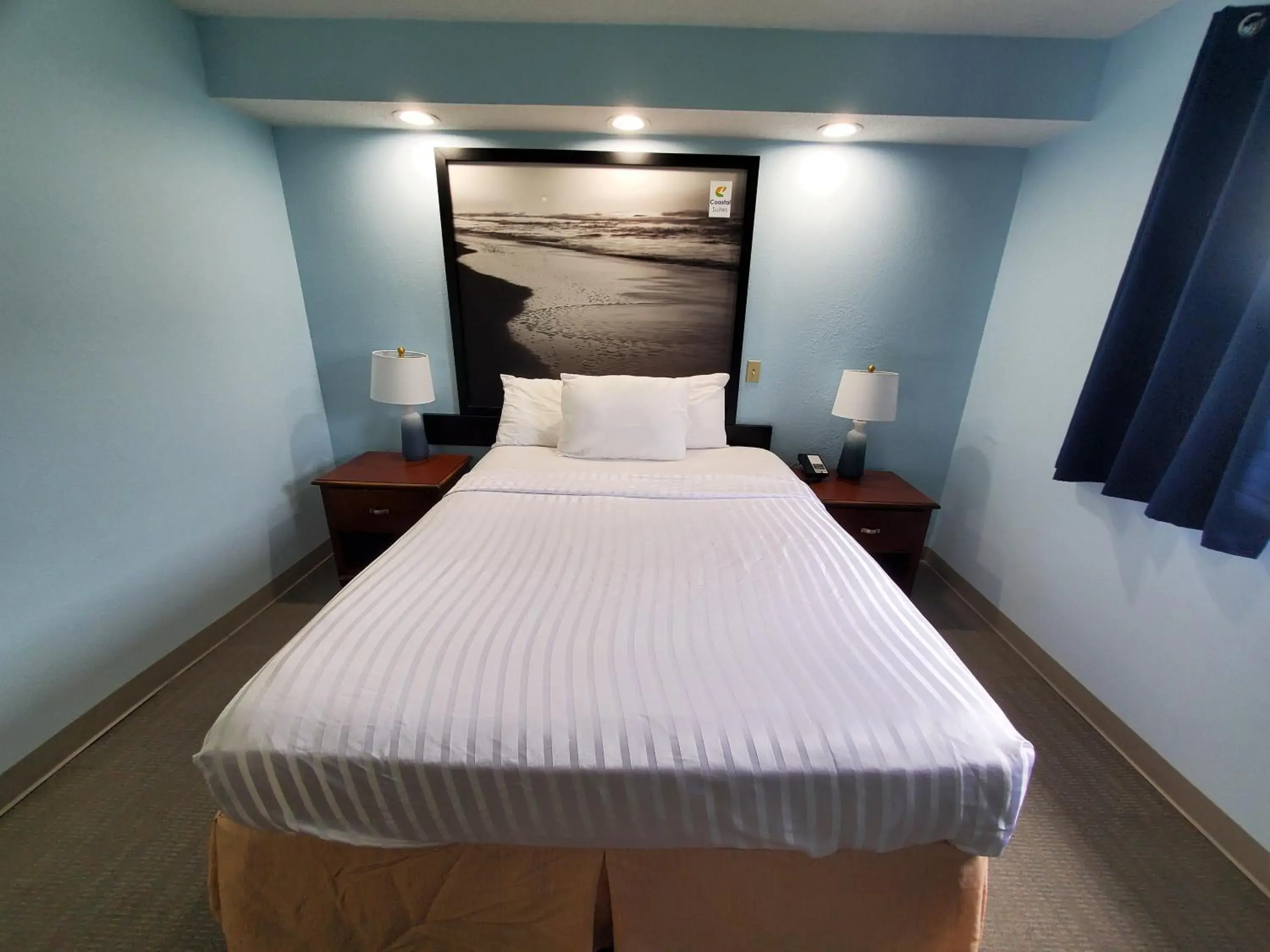 Bed in Coastal Inn & Suites