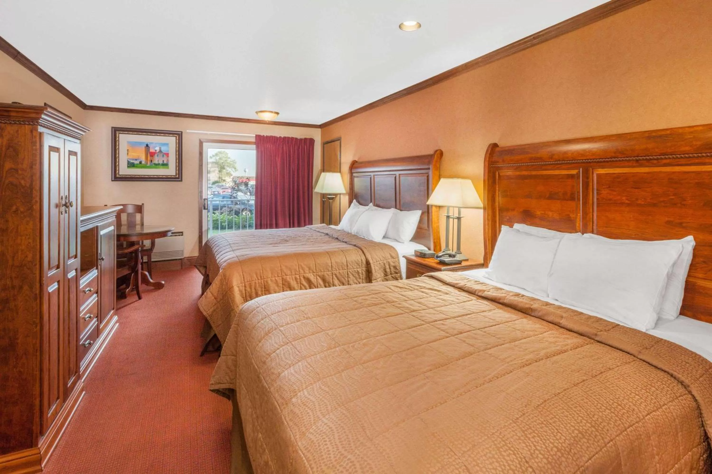 Photo of the whole room, Bed in Ramada by Wyndham Mackinaw City Waterfront