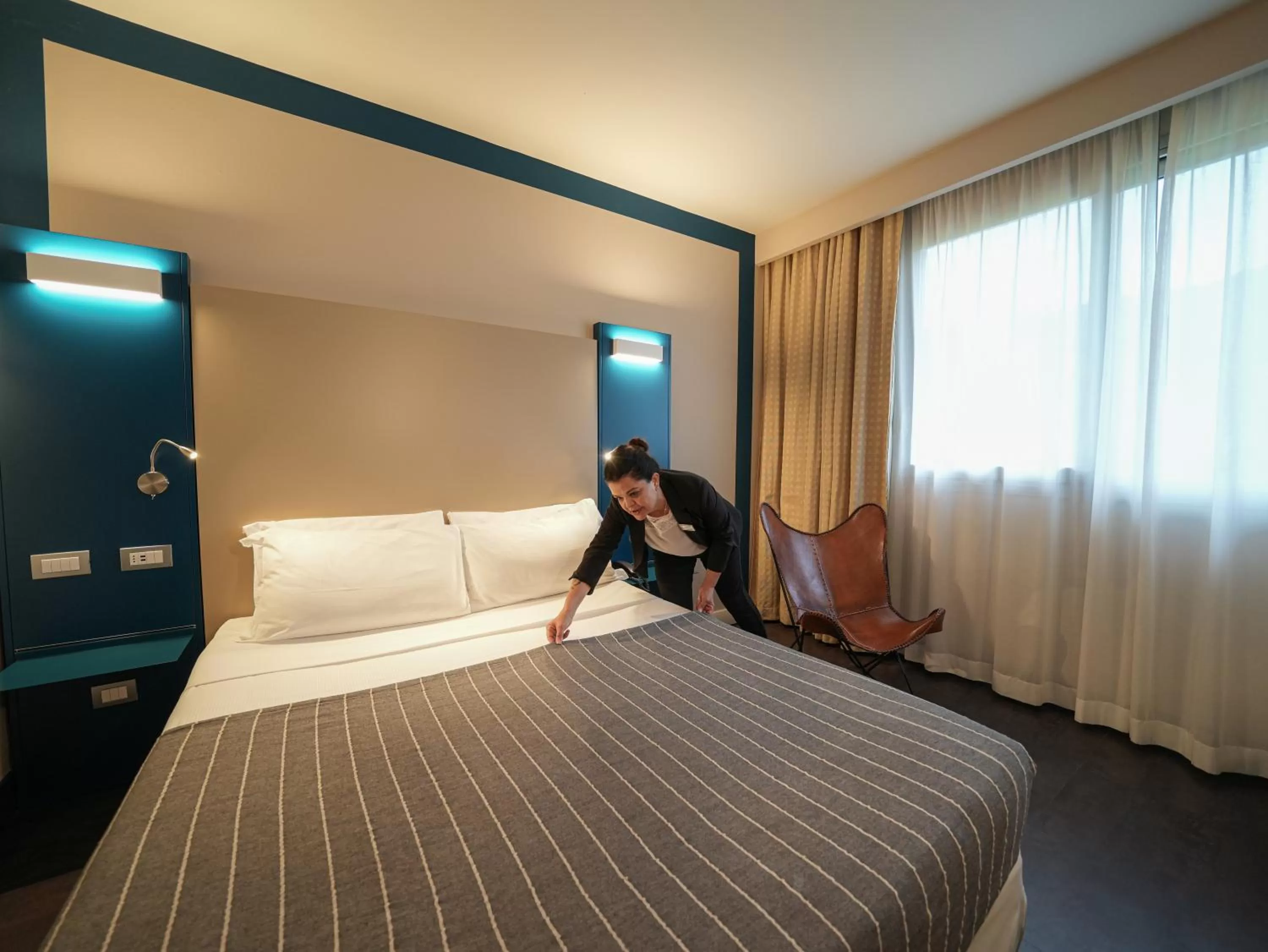 Bed in La Meridiana Bleisure Hotel