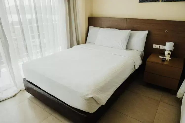 Bed in Ocean Suites Bohol Boutique Hotel