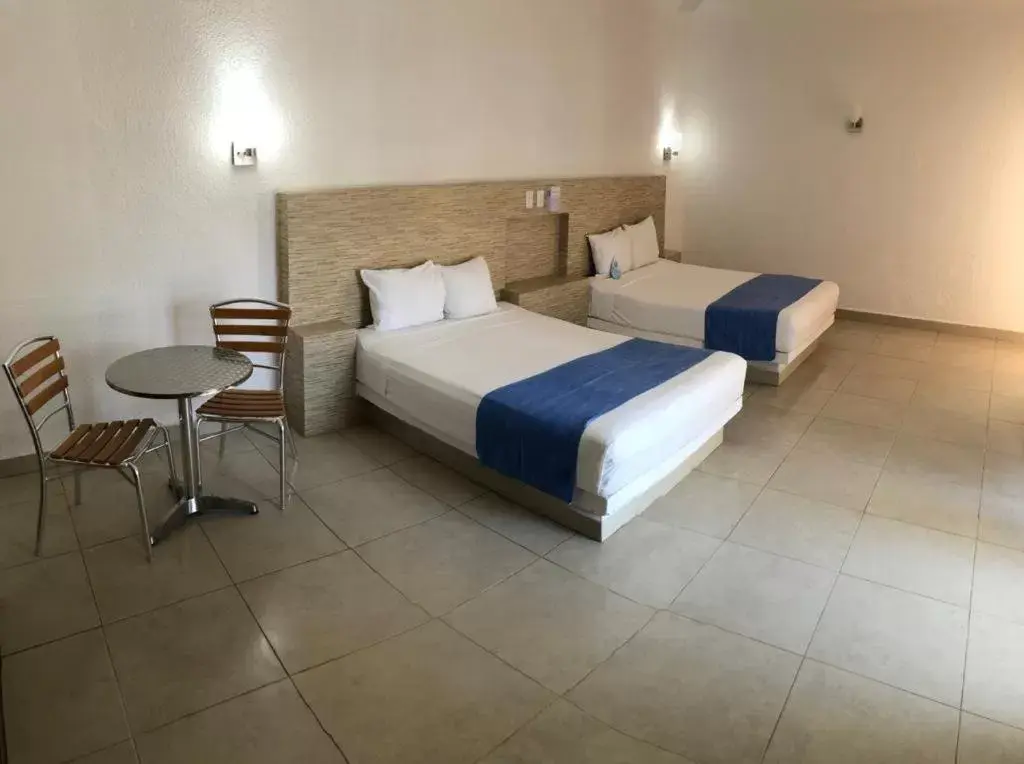 Photo of the whole room, Bed in Pelicano Inn Playa del Carmen - Beachfront Hotel