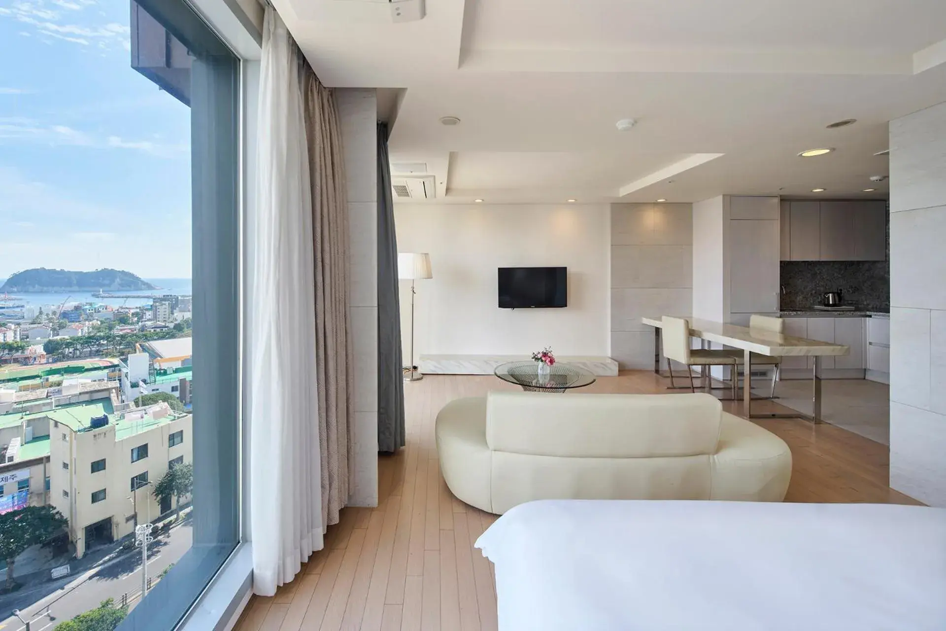 Bed, Seating Area in The Island Blue Hotel