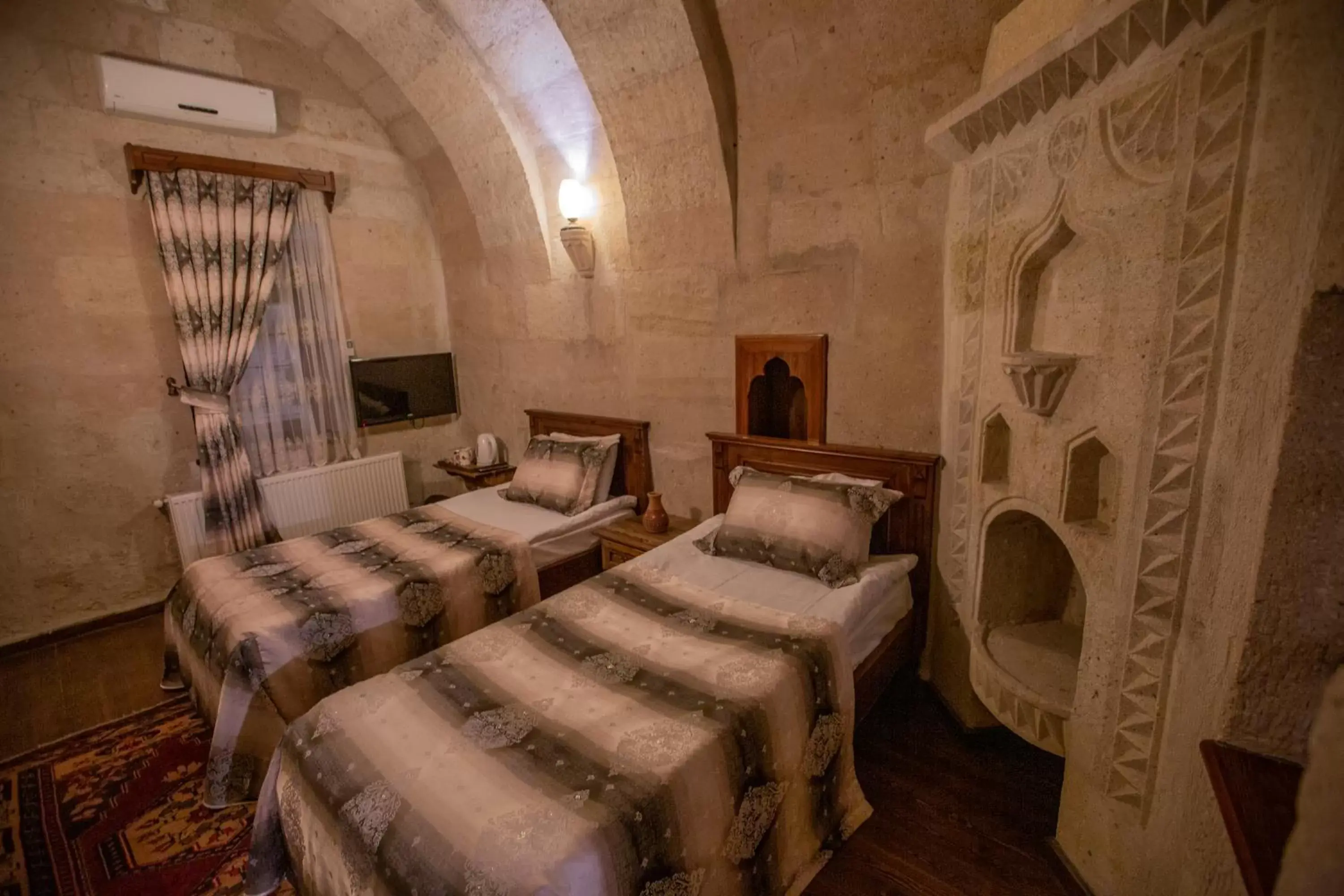 Bed in Stone House Cave Hotel