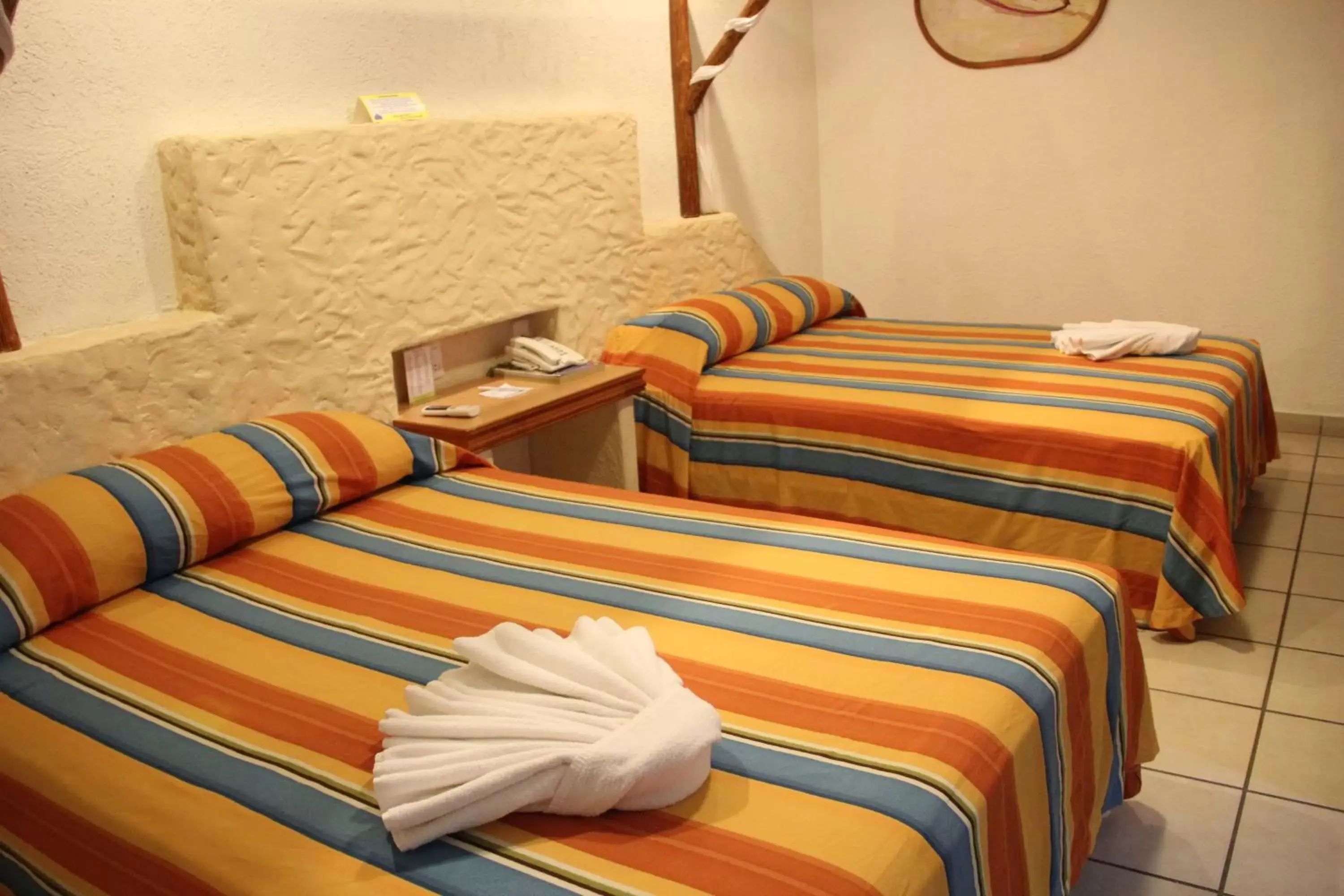 Bed in Hotel Palapa Palace Inn