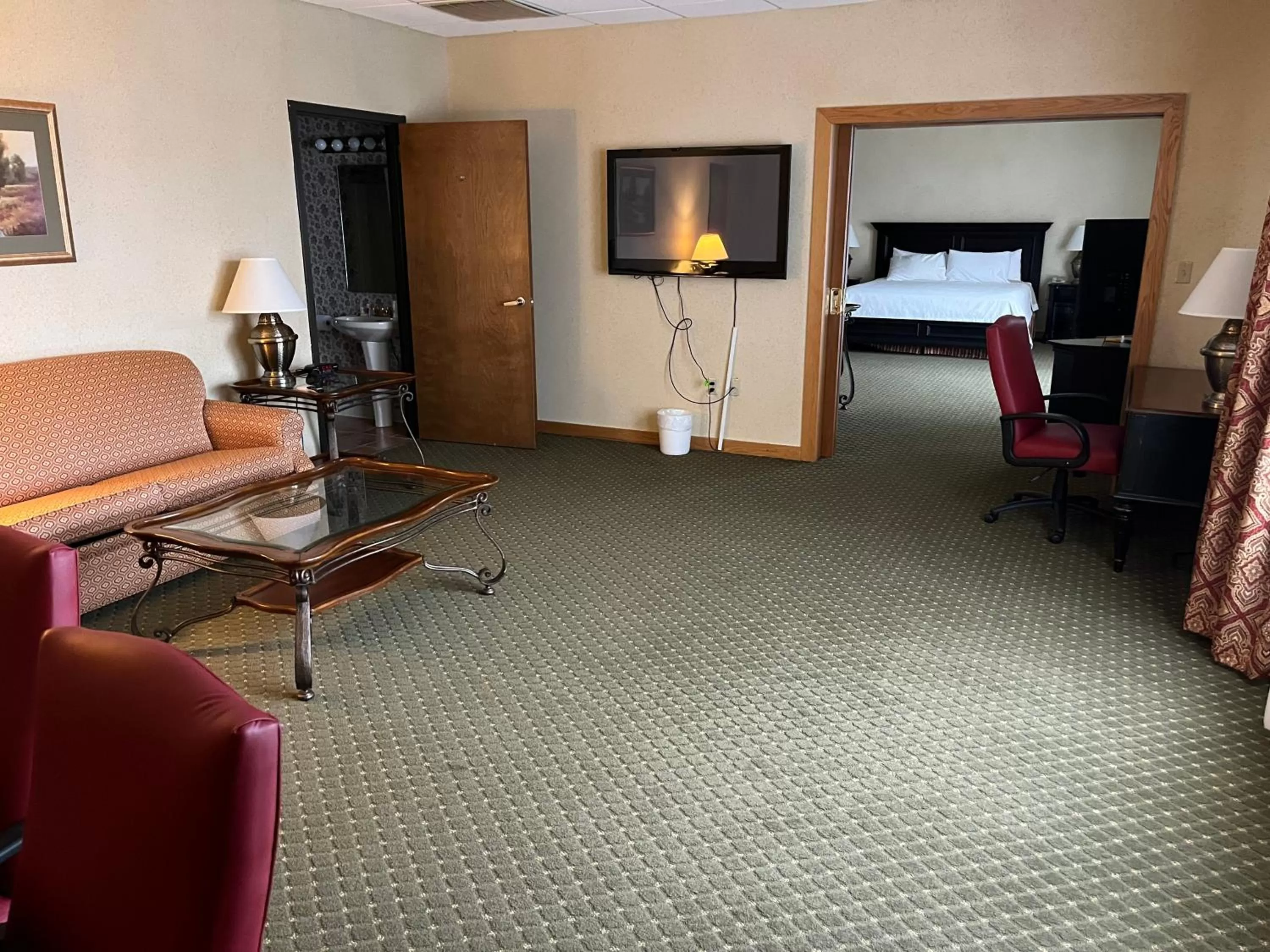 Seating area, Bed in Days Inn & Suites by Wyndham Sutton Flatwoods