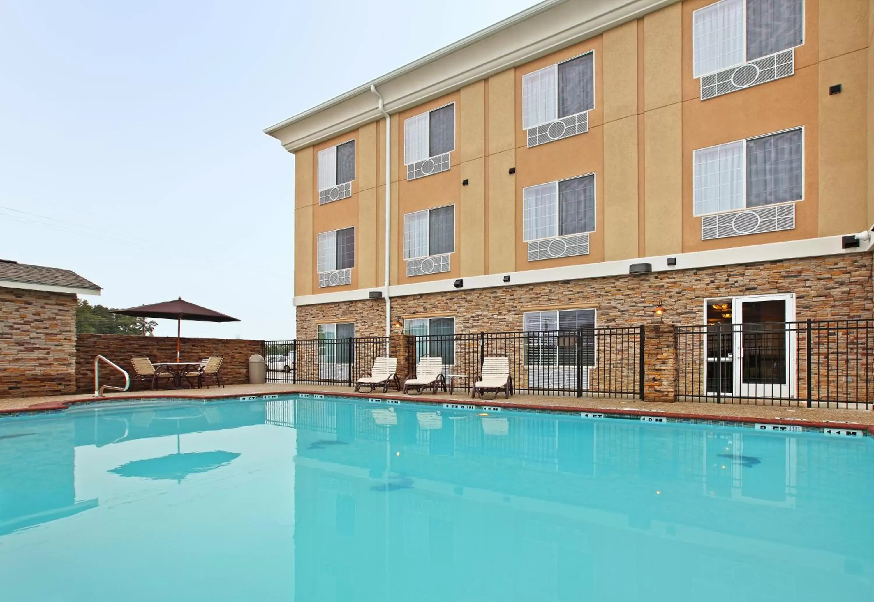 Swimming pool, Property Building in Holiday Inn Express Hotel & Suites Carthage, an IHG Hotel