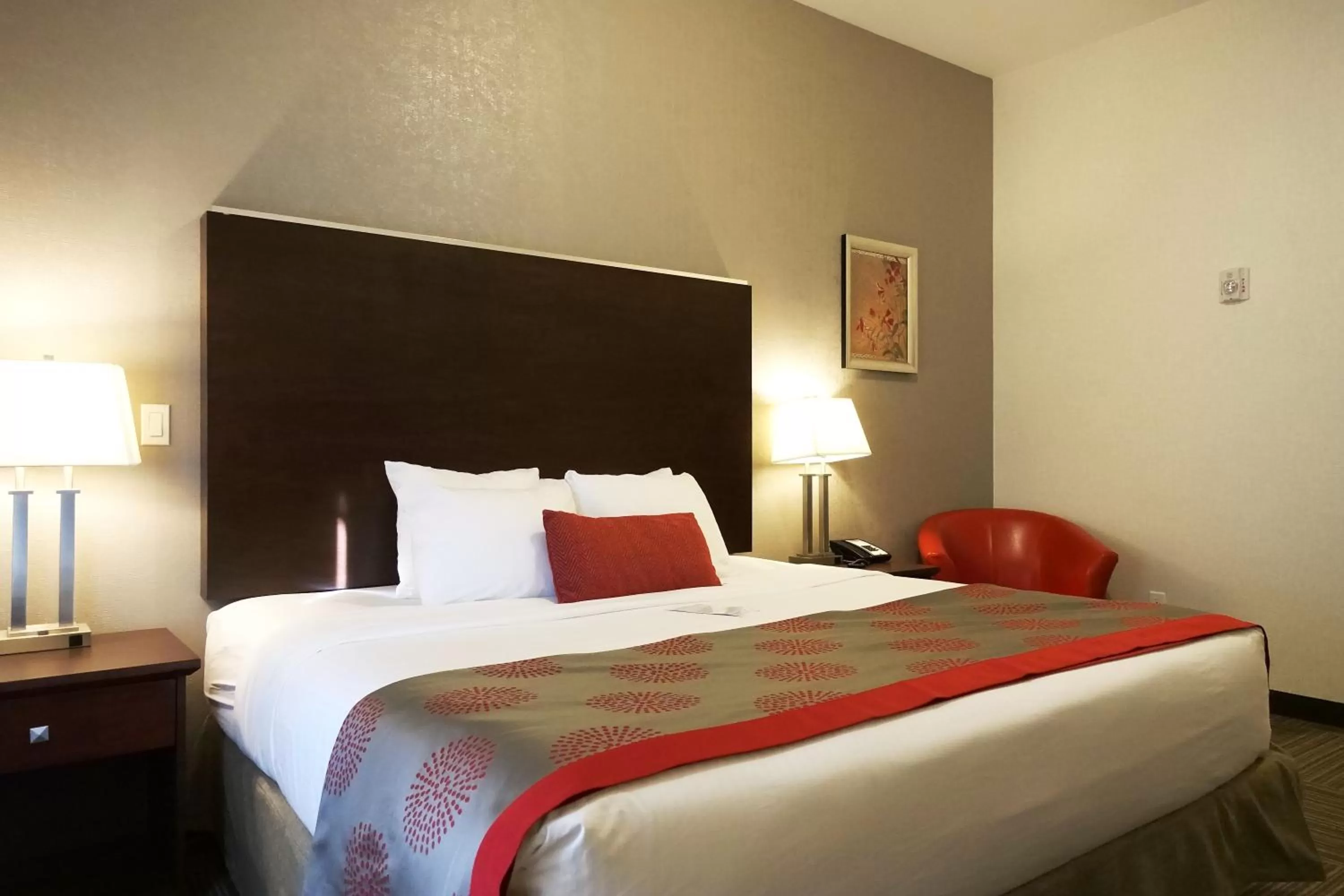 Seating area, Bed in Ramada by Wyndham Moose Jaw