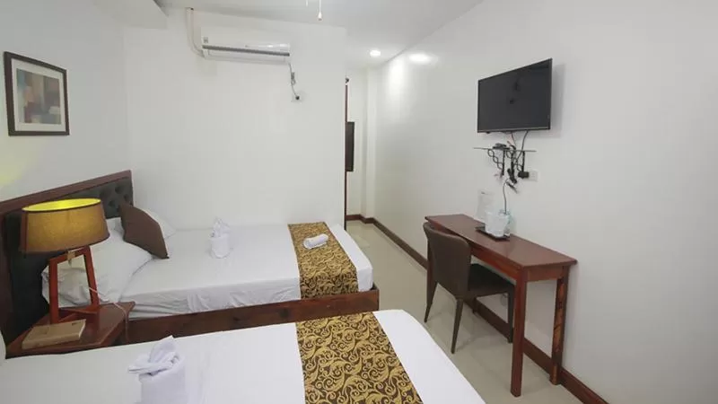 Bed in El Nido Royal Palm Inn